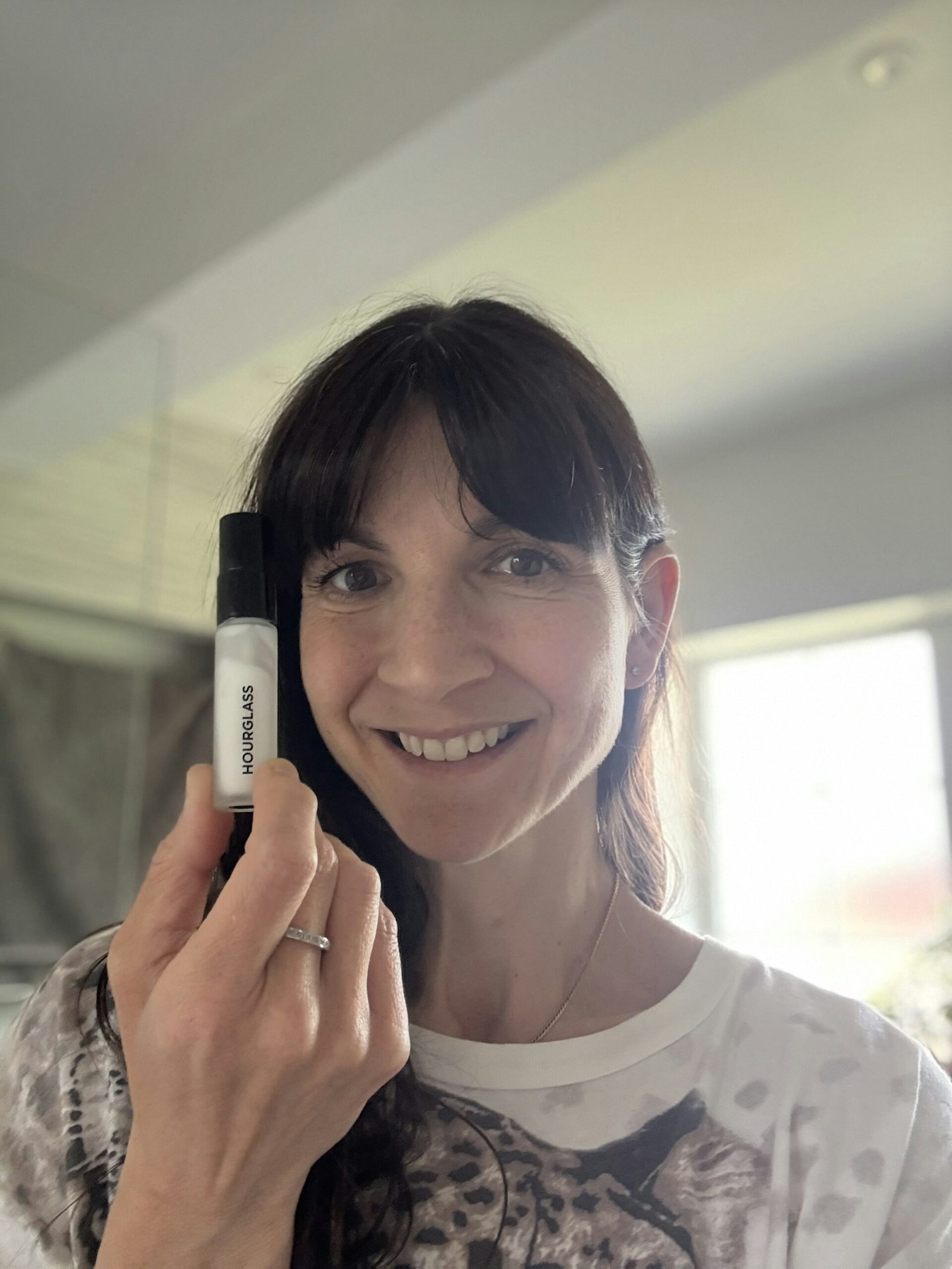 Tester holding the Hourglass Veil Mineral Primer