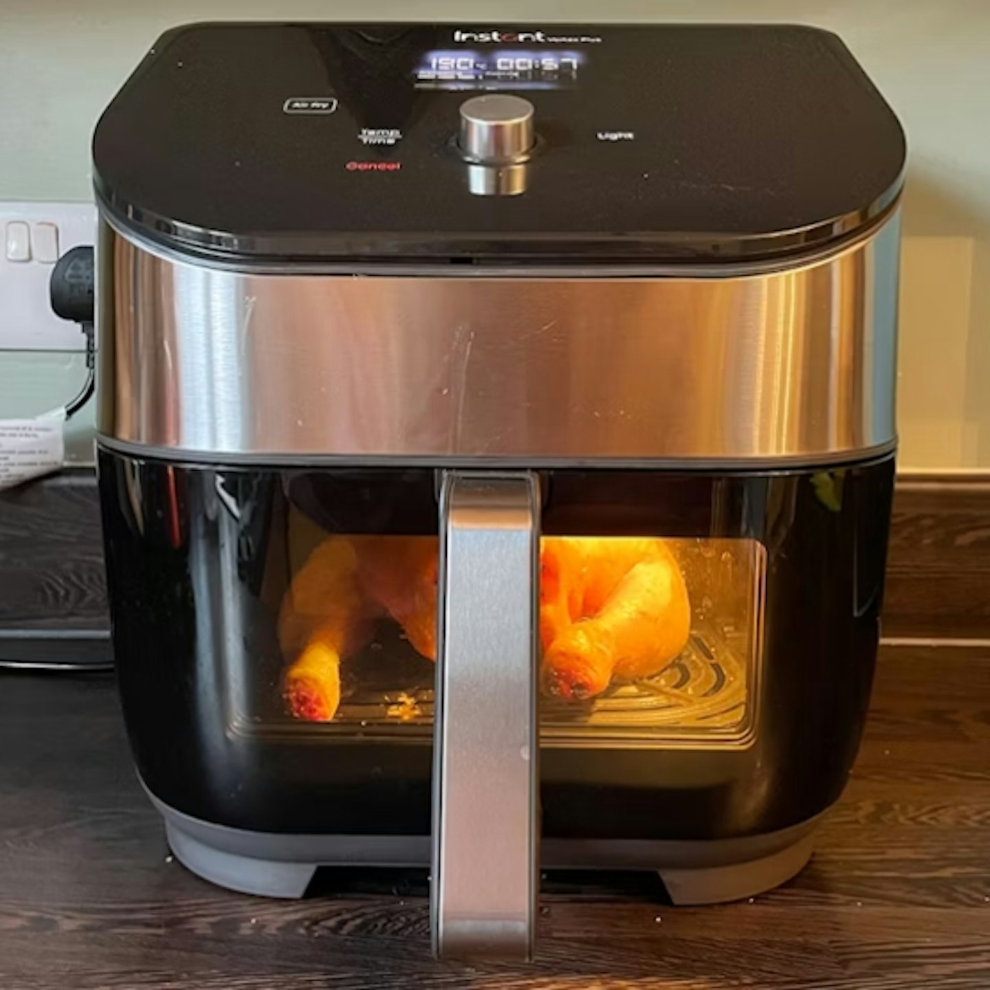 Instant Vortex Plus 6-in-1 ClearCook 5.7L Air Fryer on with a chicken roasting inside