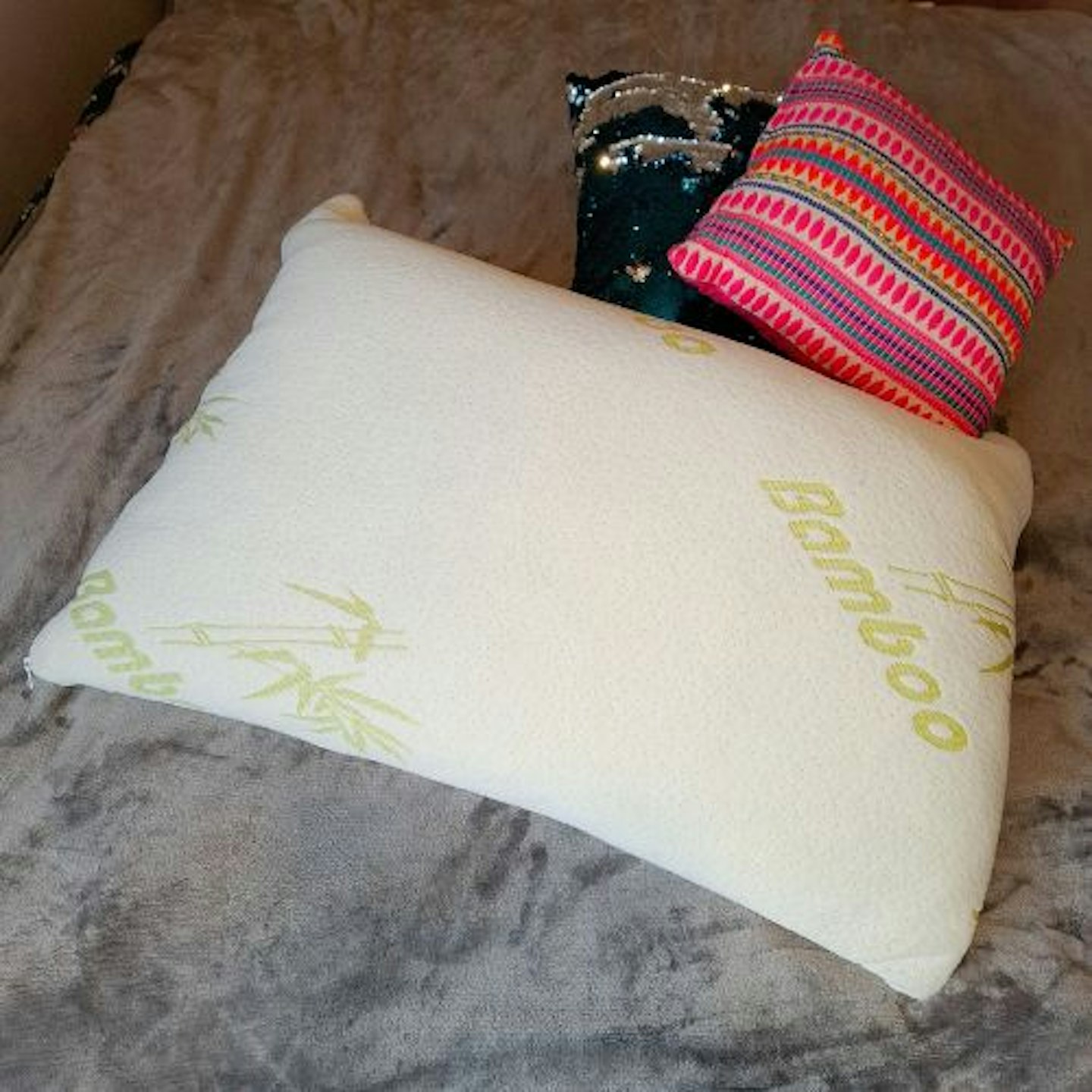 Tester's photo of the Medium Support Bamboo Memory Foam Pillow next to cushions for size comparison