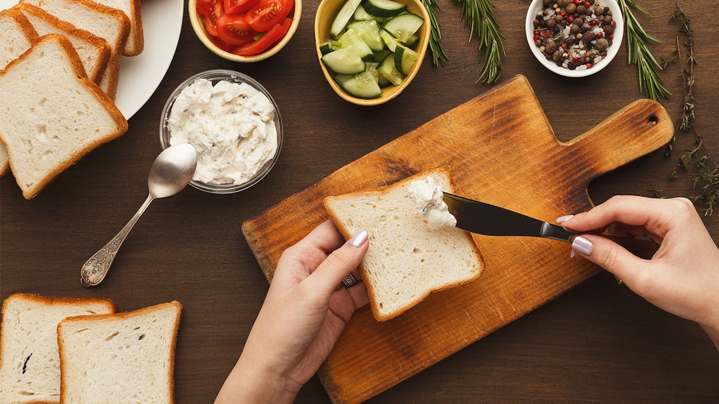 woman buttering low-calorie bread
