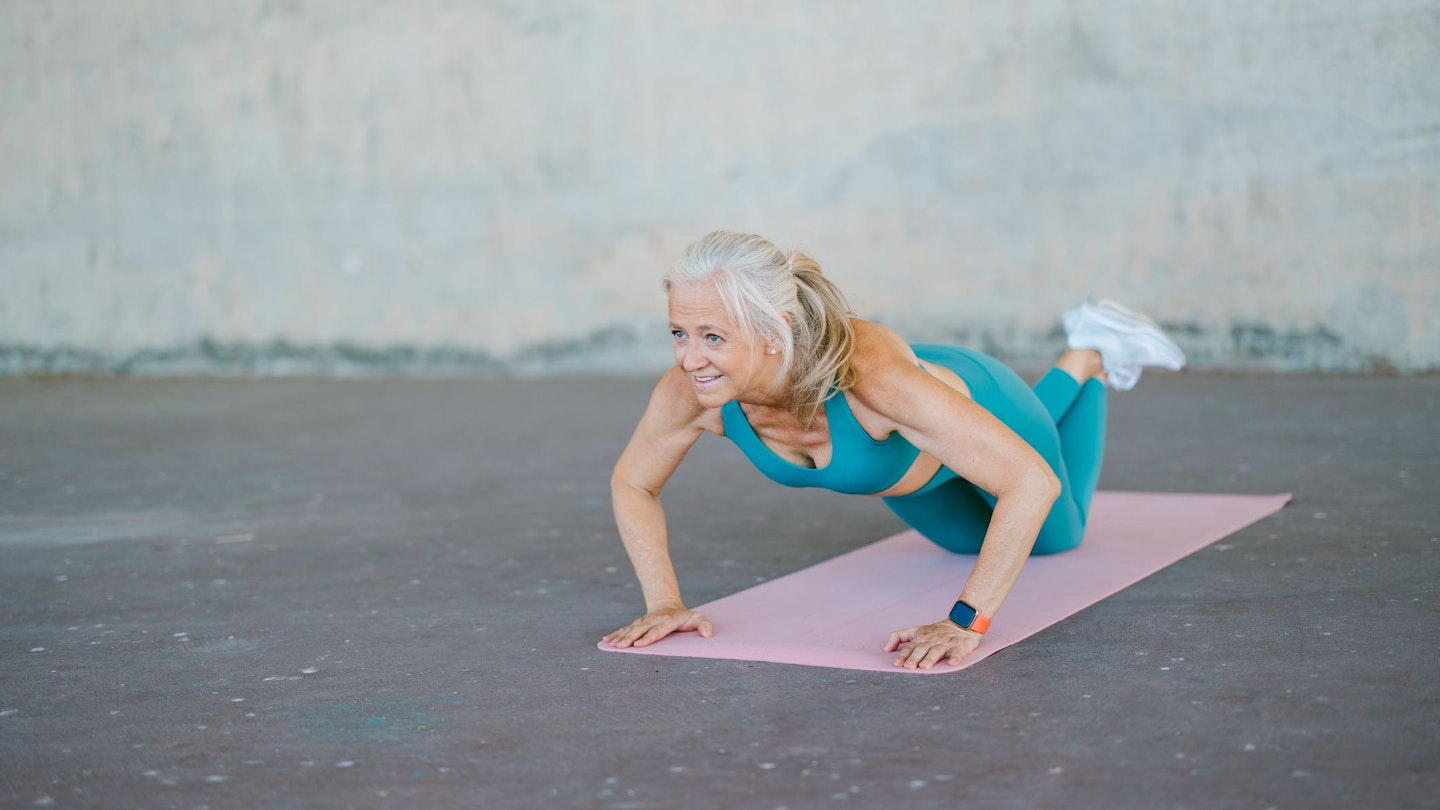 Woman doing push-ups on her knees