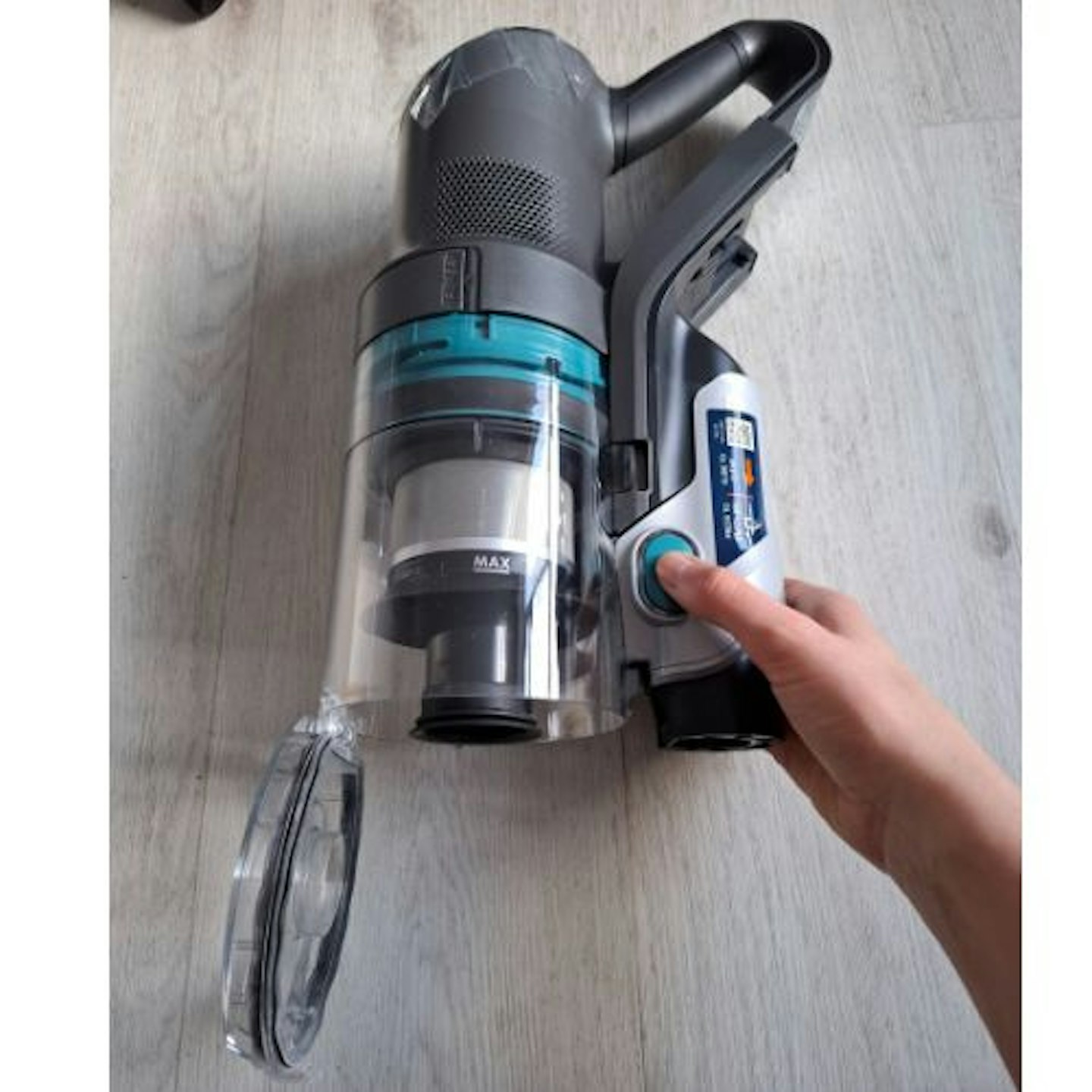 tester shows the button that releases the dust collection container base