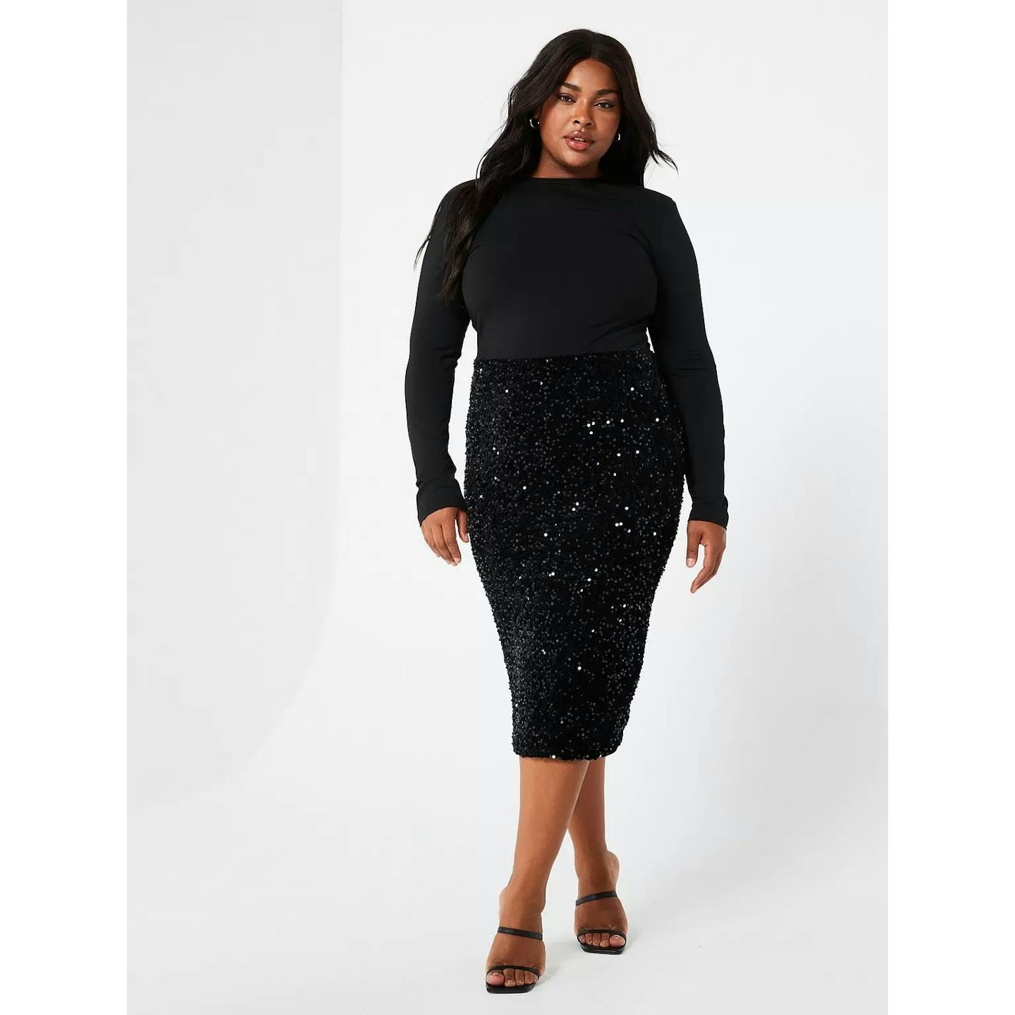 Woman in a black sequined midi dress 