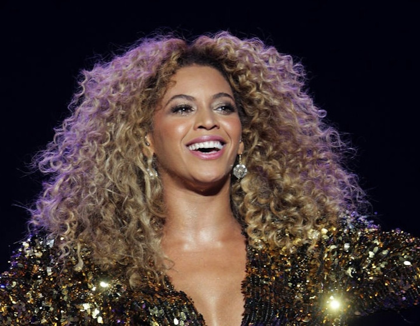 Beyonce performing at The Glastonbury Festival 2011 in a golden suit