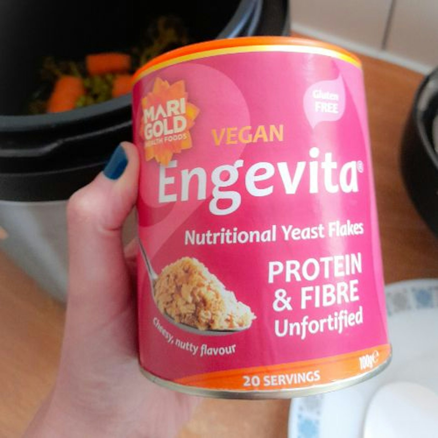 photo of Vegan Marigold Engevita Yeast Flakes in tester's hand with Crockpot in the background