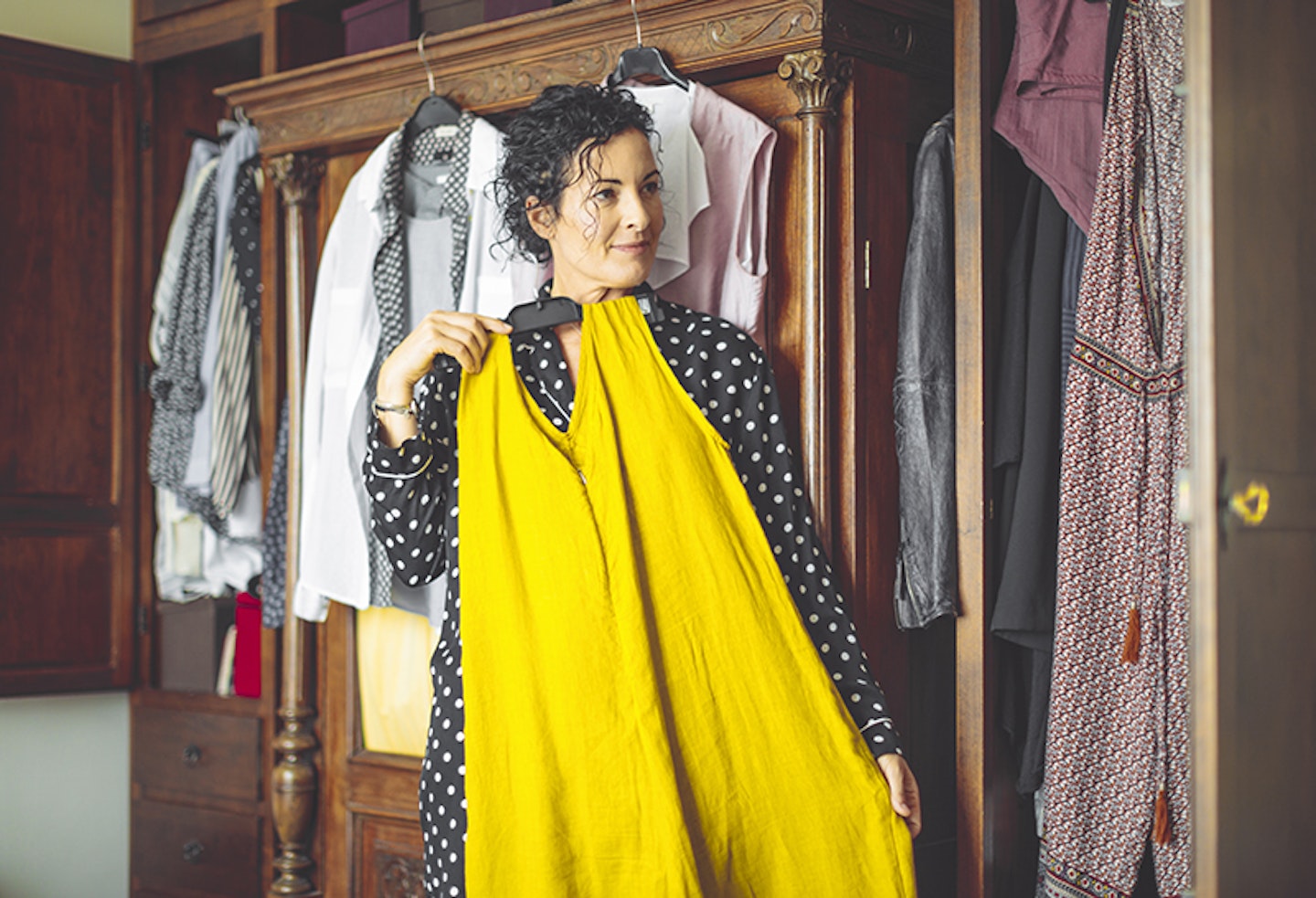 woman dressing near wardrobe