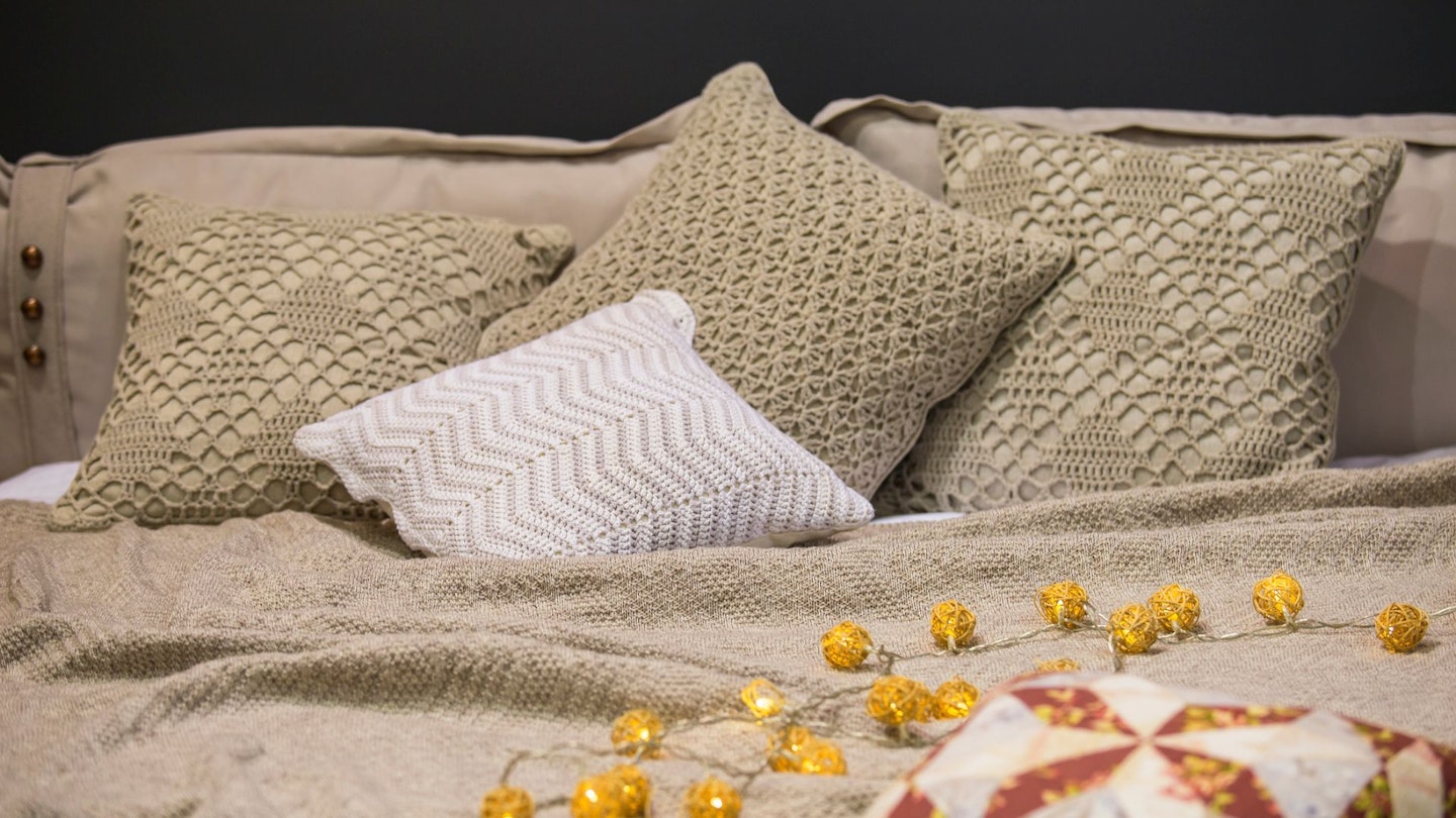 Knitted bed linens, knitted pillow cases, pillows, bedspreads, gray beige colors, Scandinavian style.