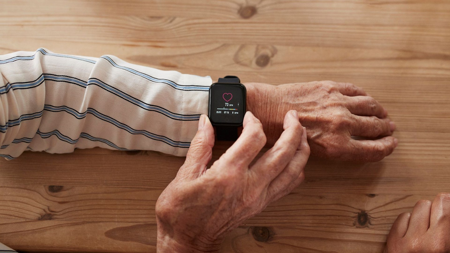 Lady using heart rate monitor watch