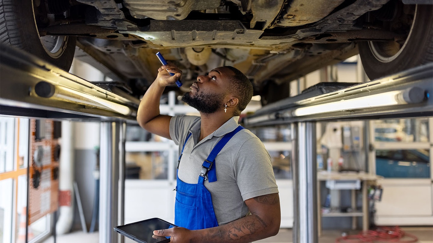 Mechanic working on pothole damage