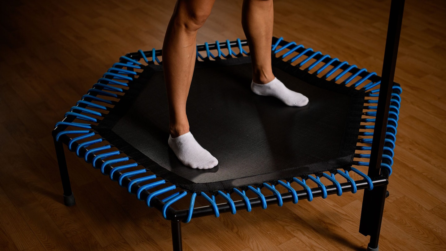Woman wearing socks on small indoor fitness trampoline