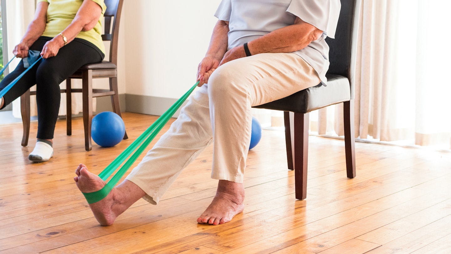 Person doing a hamstring stretch with the help of a resistance band