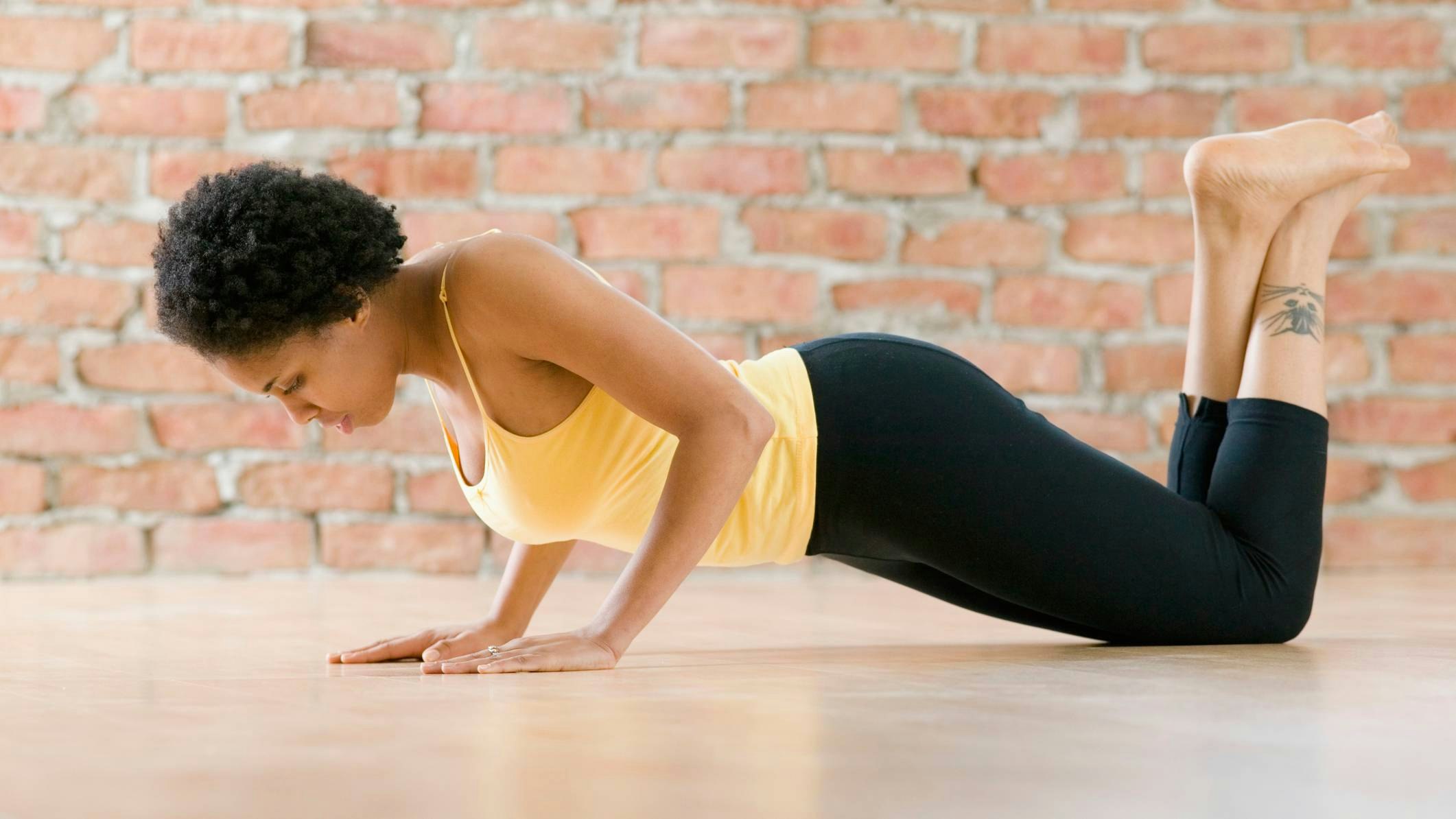 Woman performing a knee-down push-up