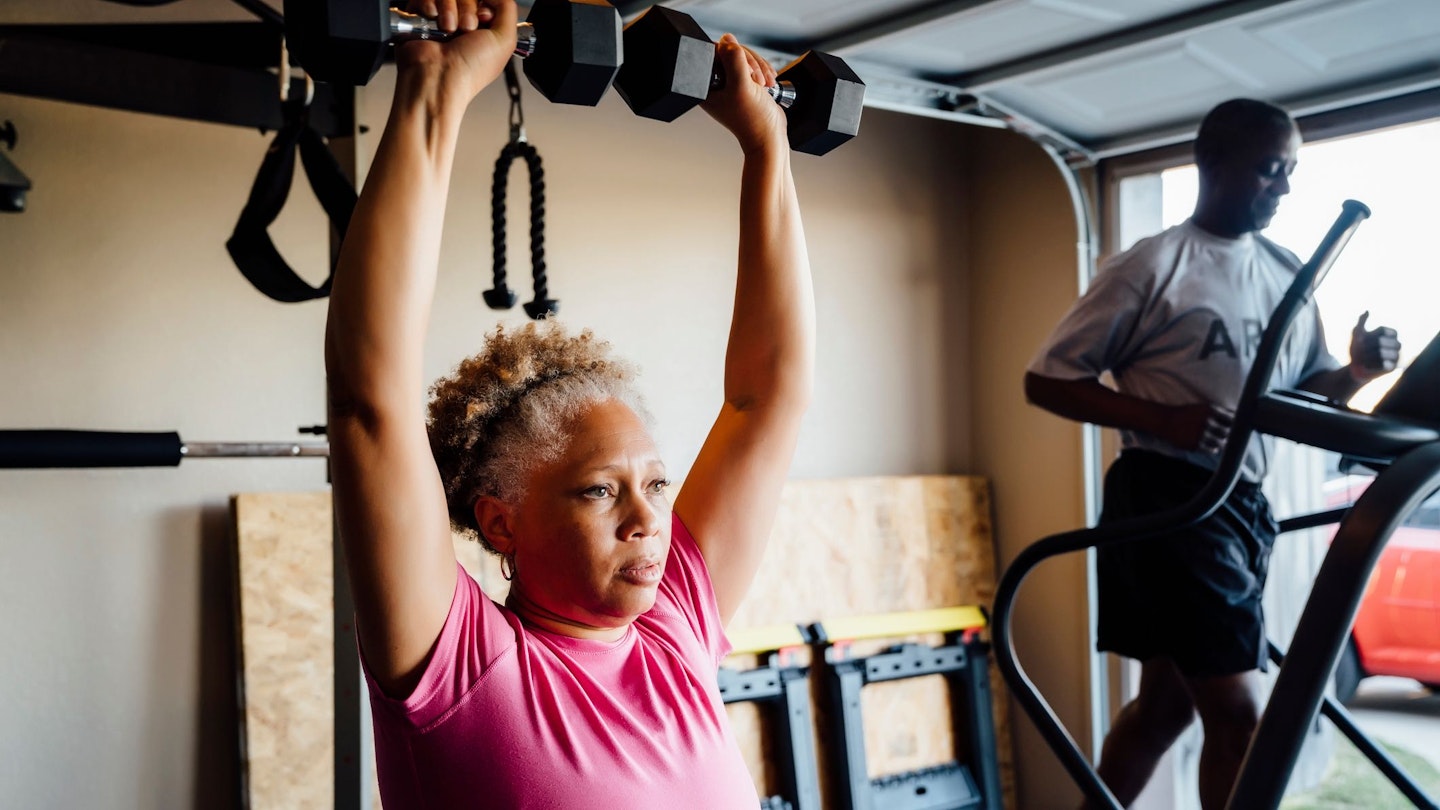 Woman pressing a pair of dumbbells overhead