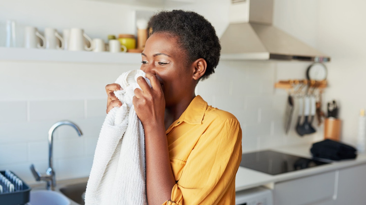 Woman smelling clean washing