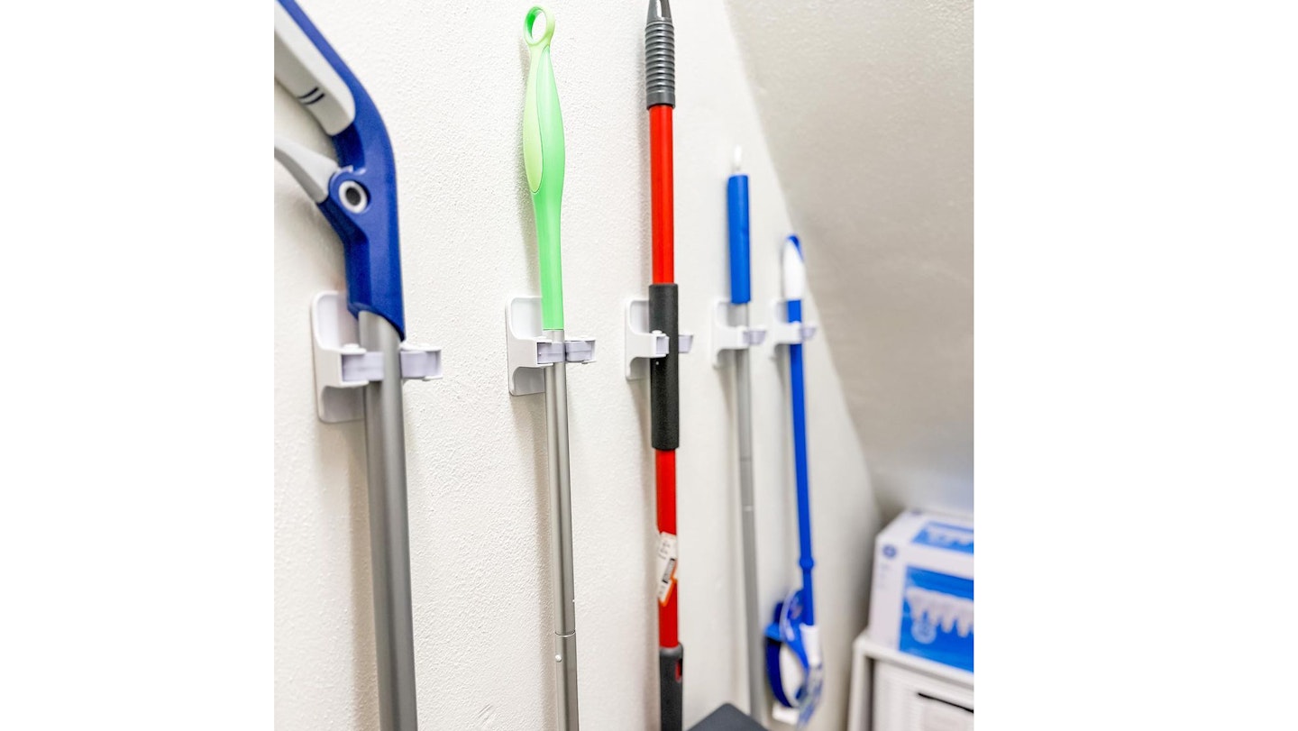 hanging brooms in understaffs cupboard