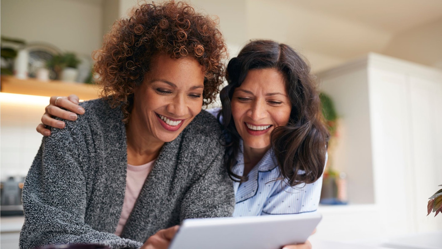 female couple looking at iPad screen