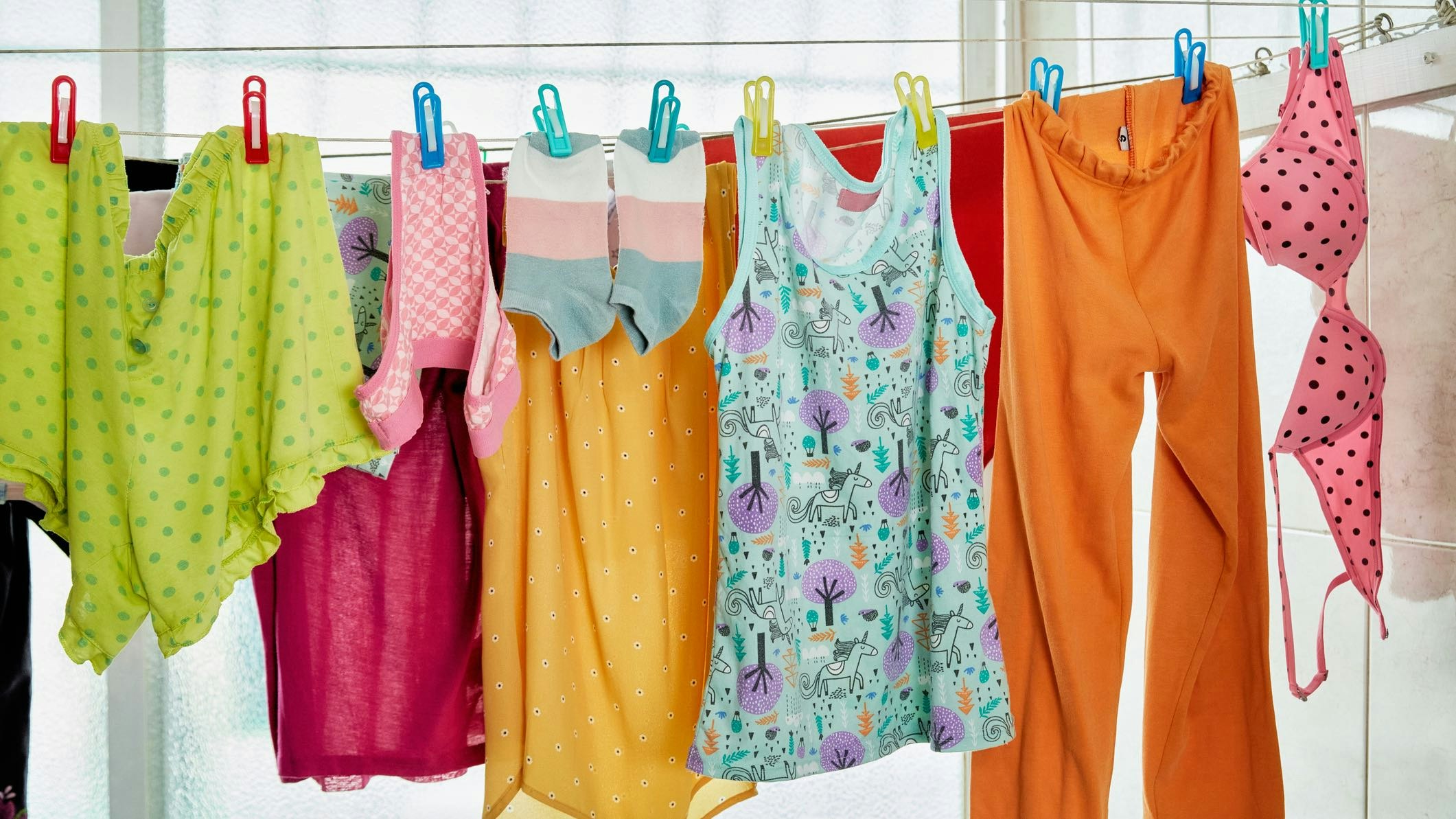 hanging clothes on an indoor line