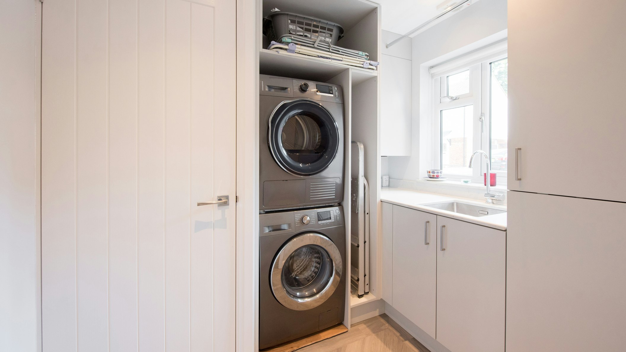 washing machine and dryer stacked in a utility room