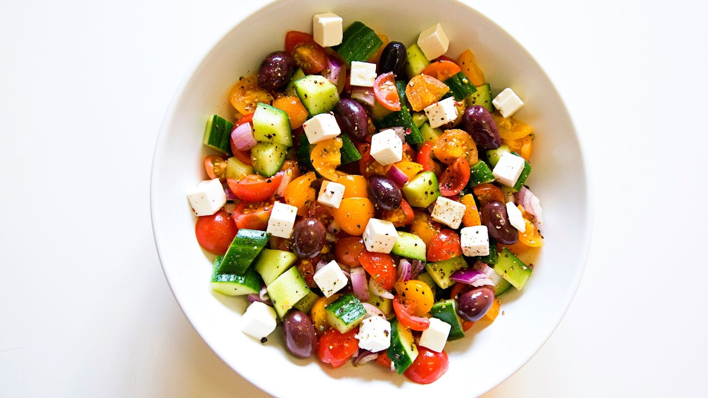 A bowl of greek salad - cucumber, tomatoes, feta cheese