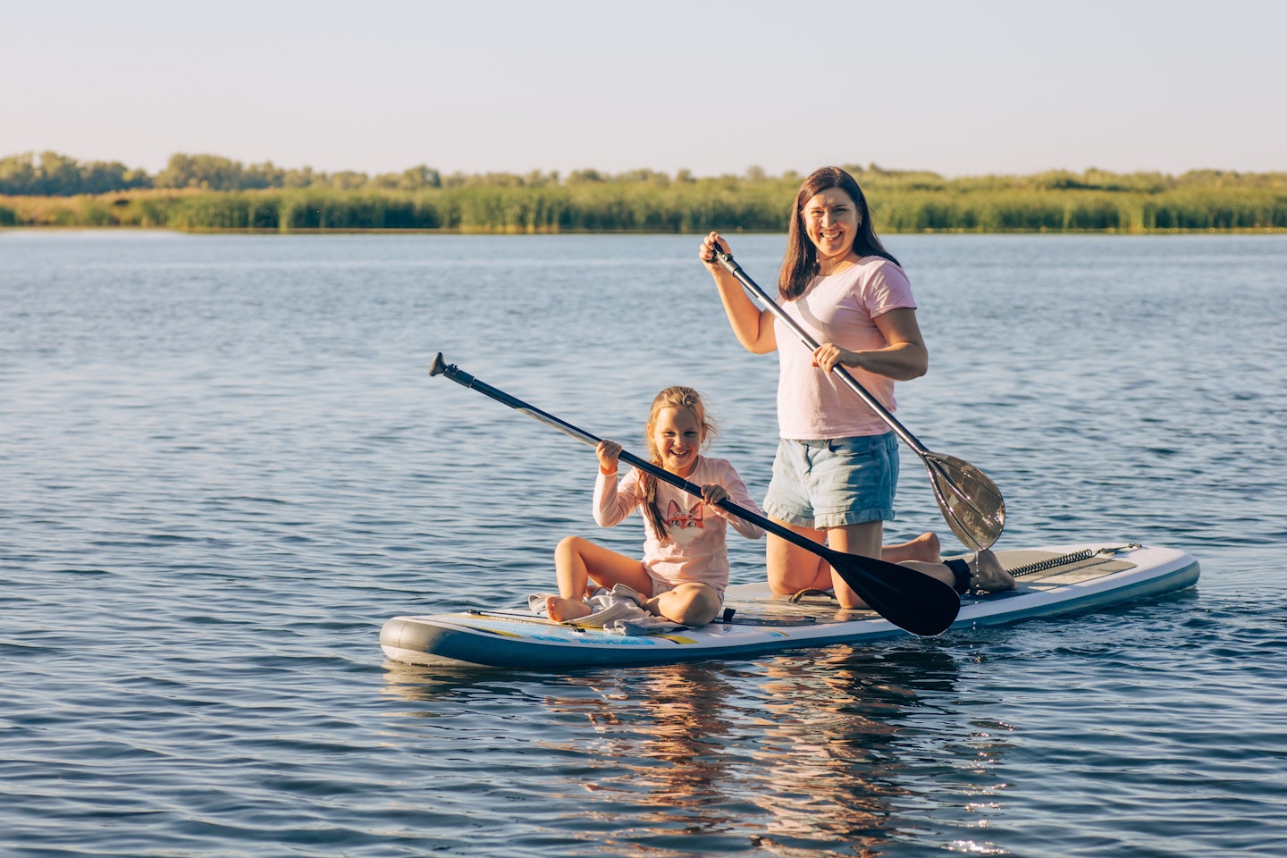 woman-and-daughter-paddleboarding