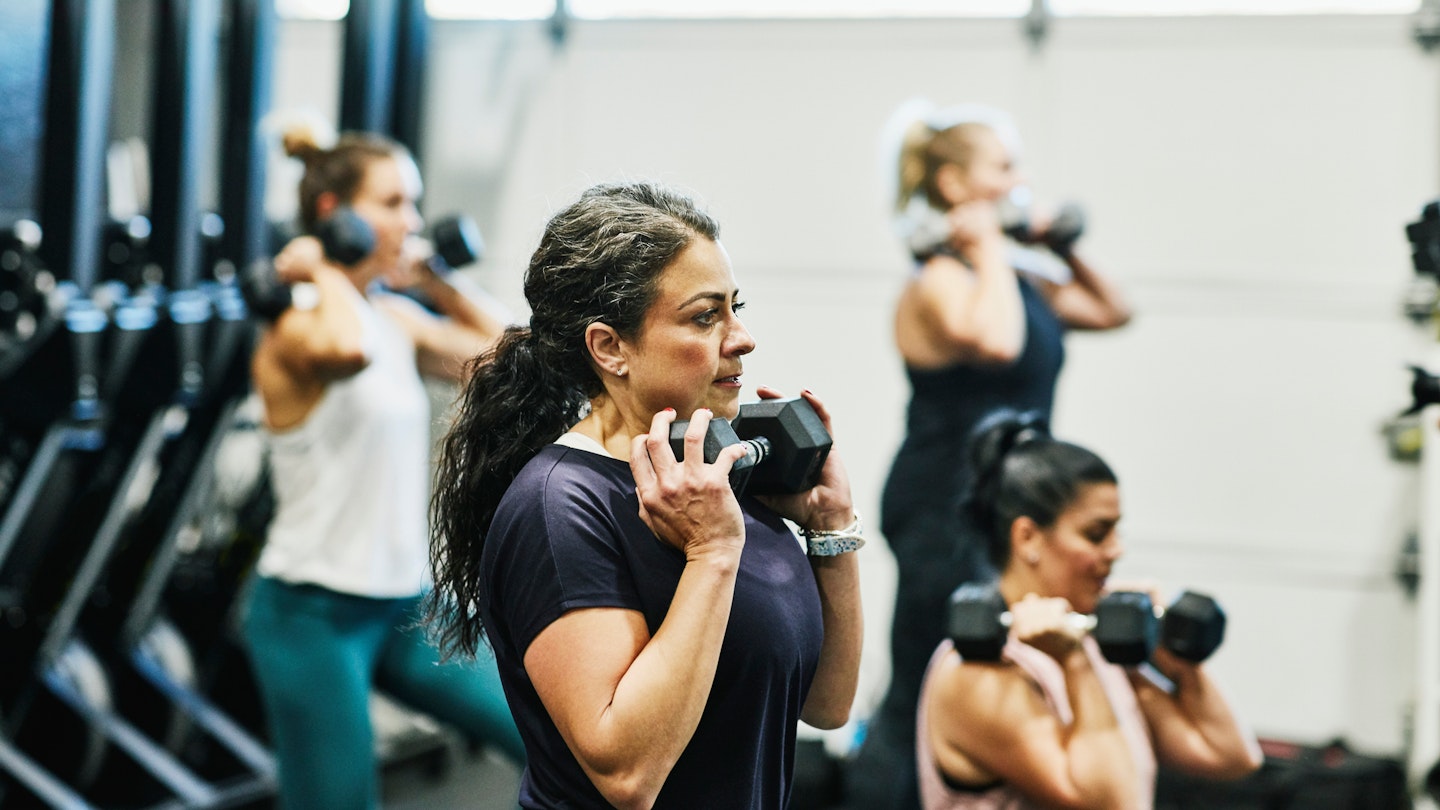 Woman lifting weights in a gym