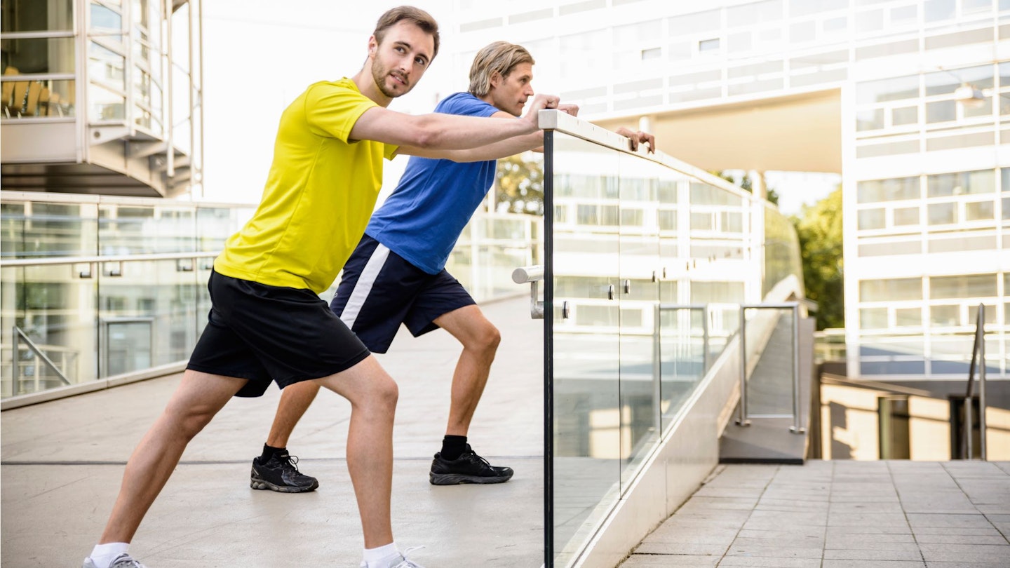 two men doing a calf stretch