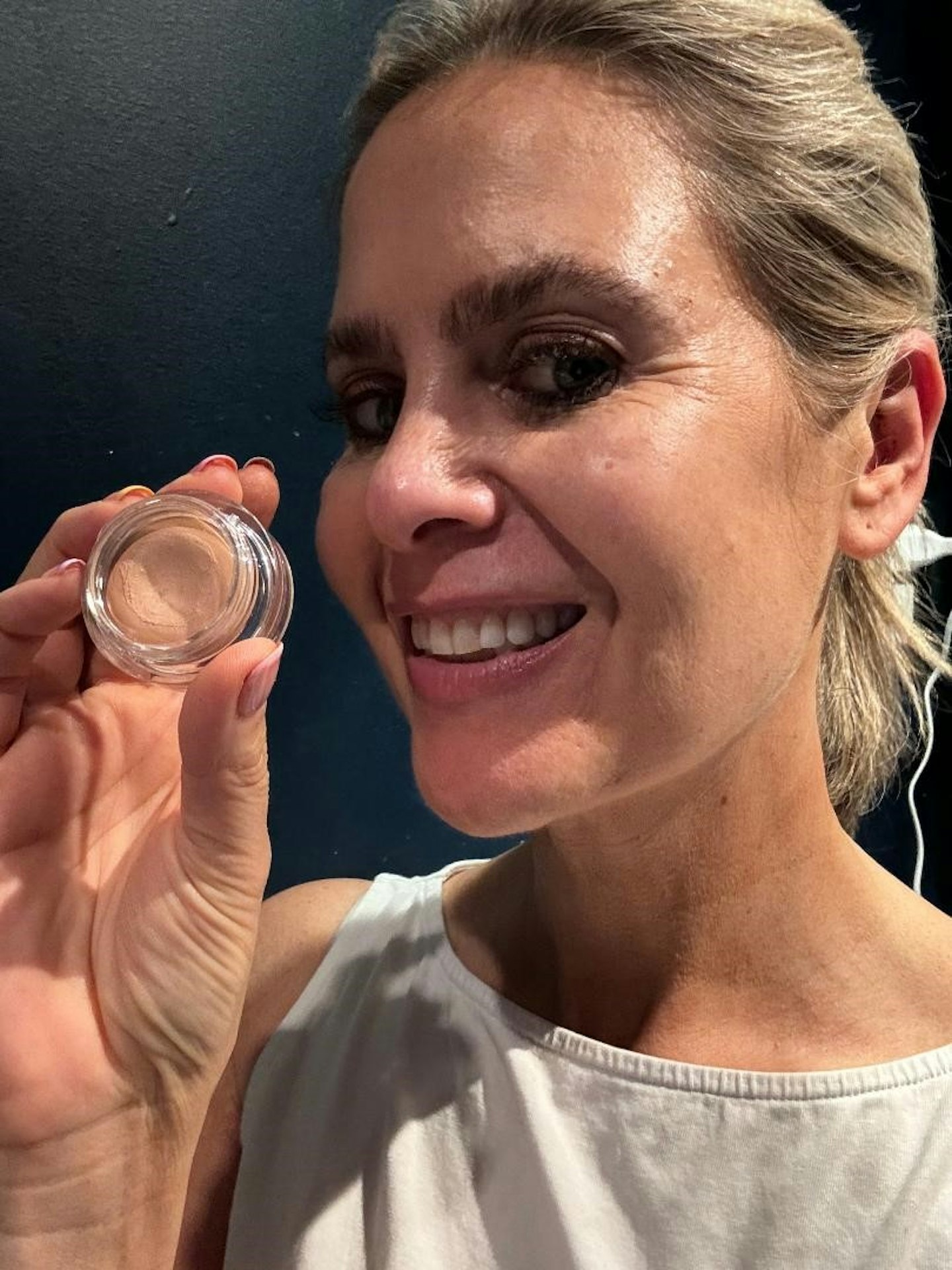 Product tester holding Trinny London Just A Touch Concealer