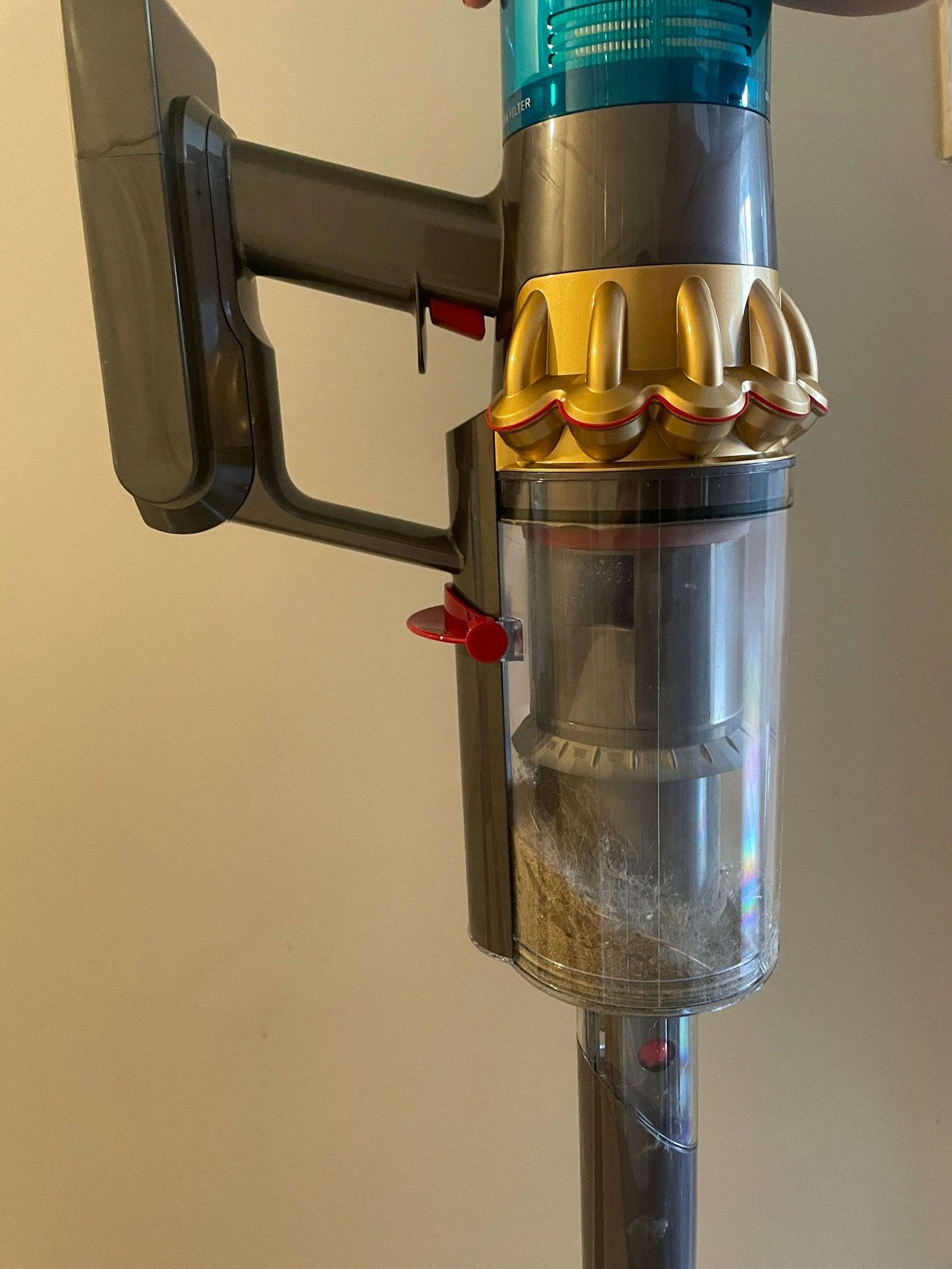 close up of the Dyson V15s Detect Absolute Cordless Vacuum Cleaner dust collection container partially full of dust and debris 