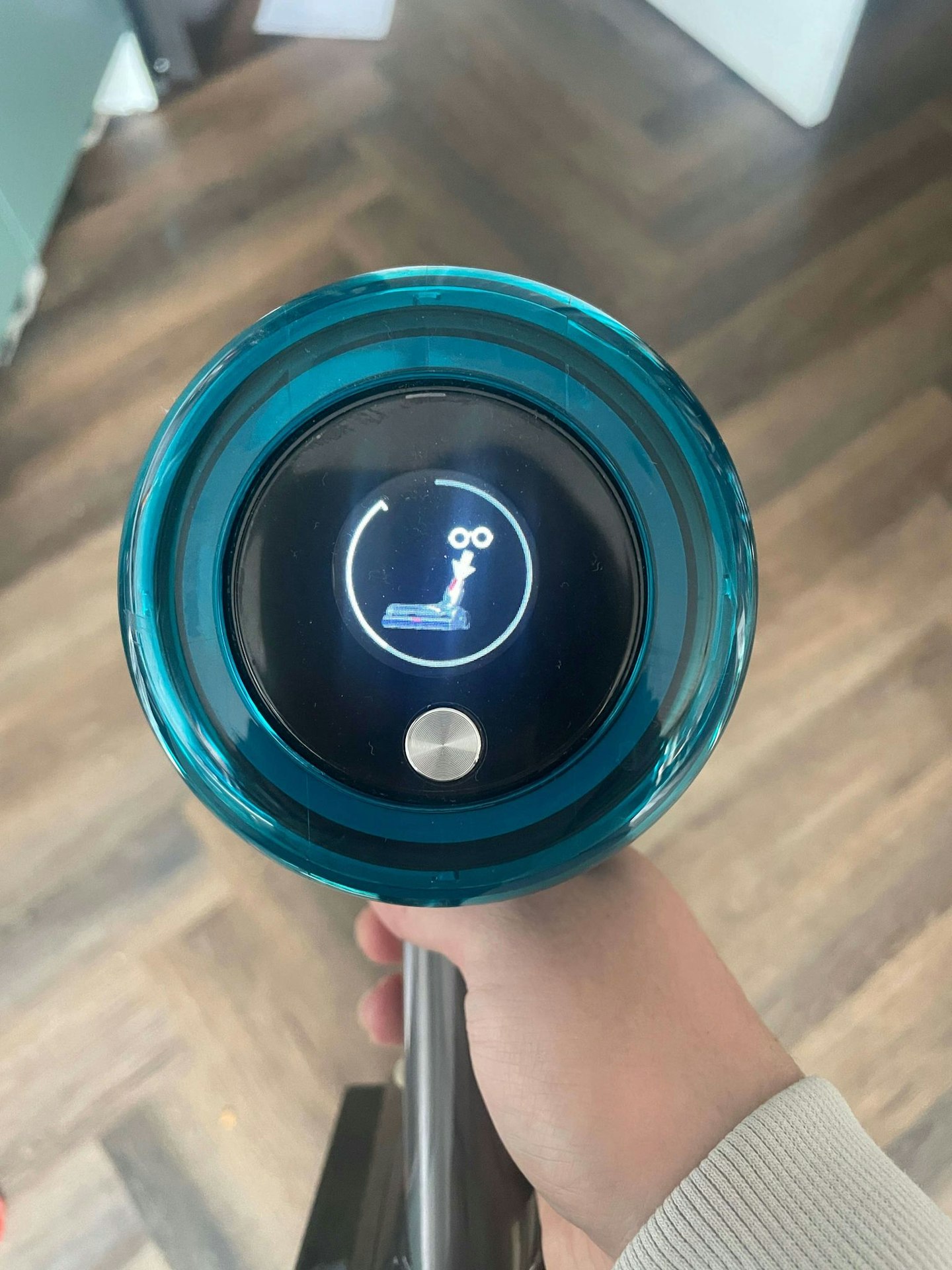 Top view of the Dyson V15s Detect Absolute Cordless Vacuum Cleaner showing the digital display, hardwood floor in the background 