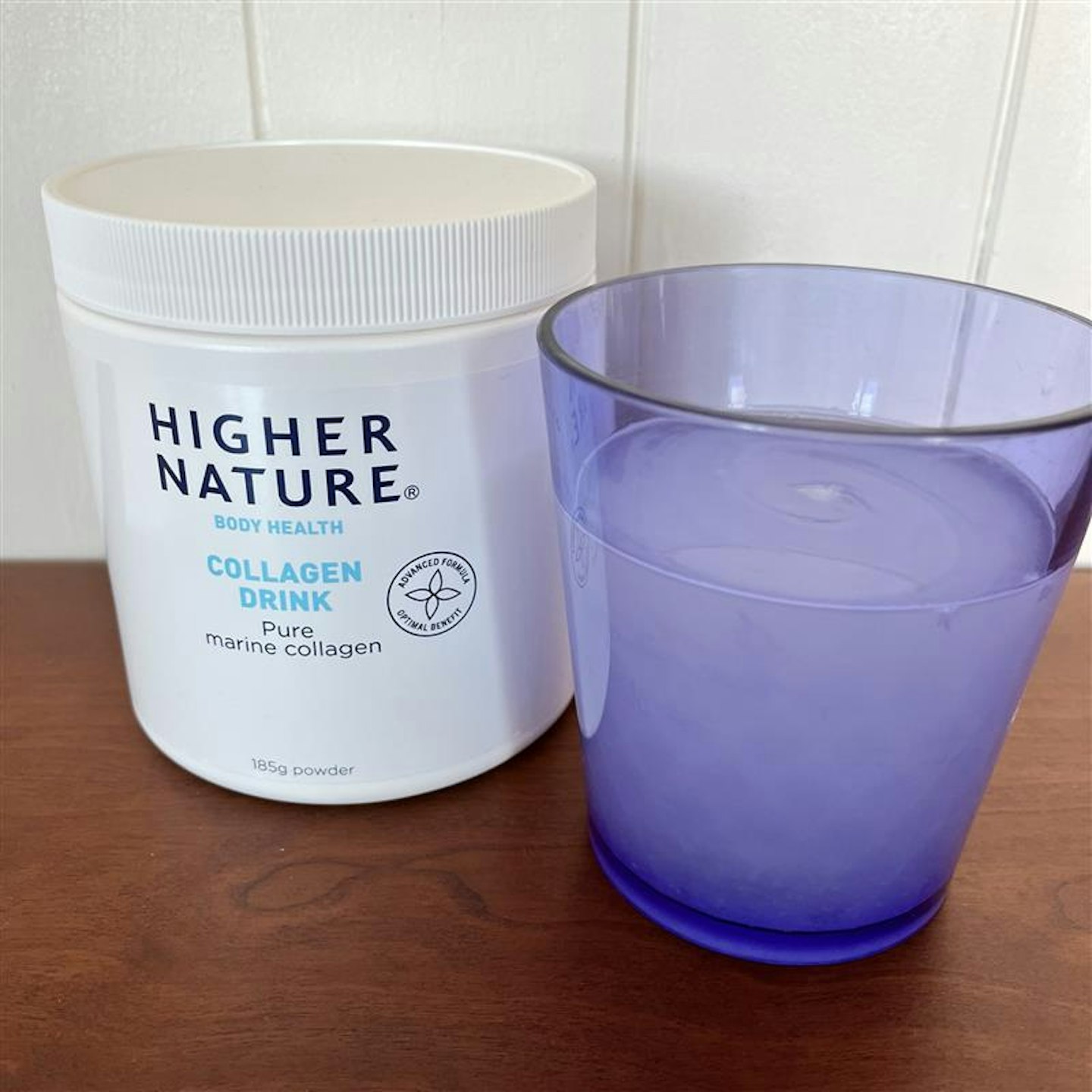 Higher Nature marine collagen drink packaging plus the powder dissolved in water 