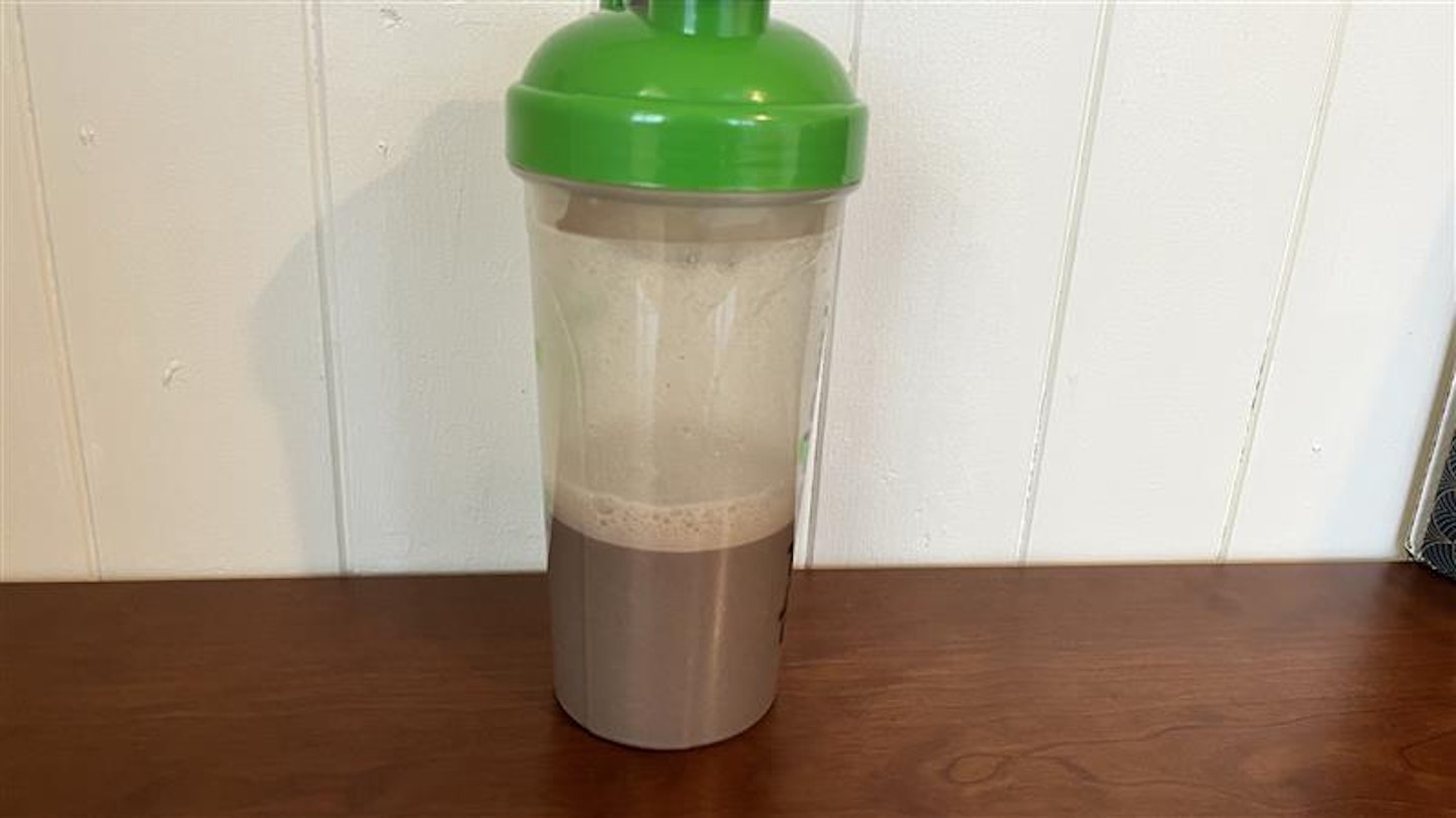 Biotech vegan protein shake in plastic cup chocolate and cinnamon flavor 