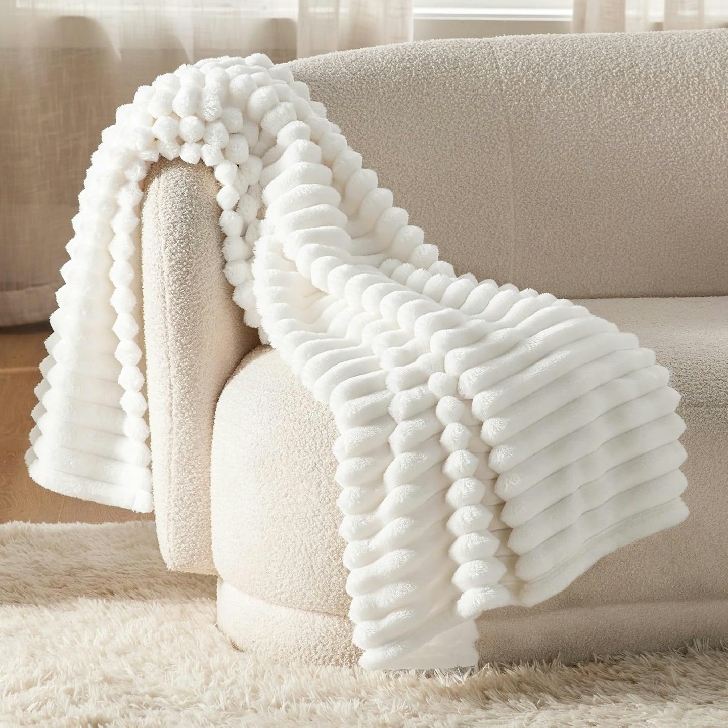 Bedsure Soft Fleece Throw Blanket over a beige sofa 