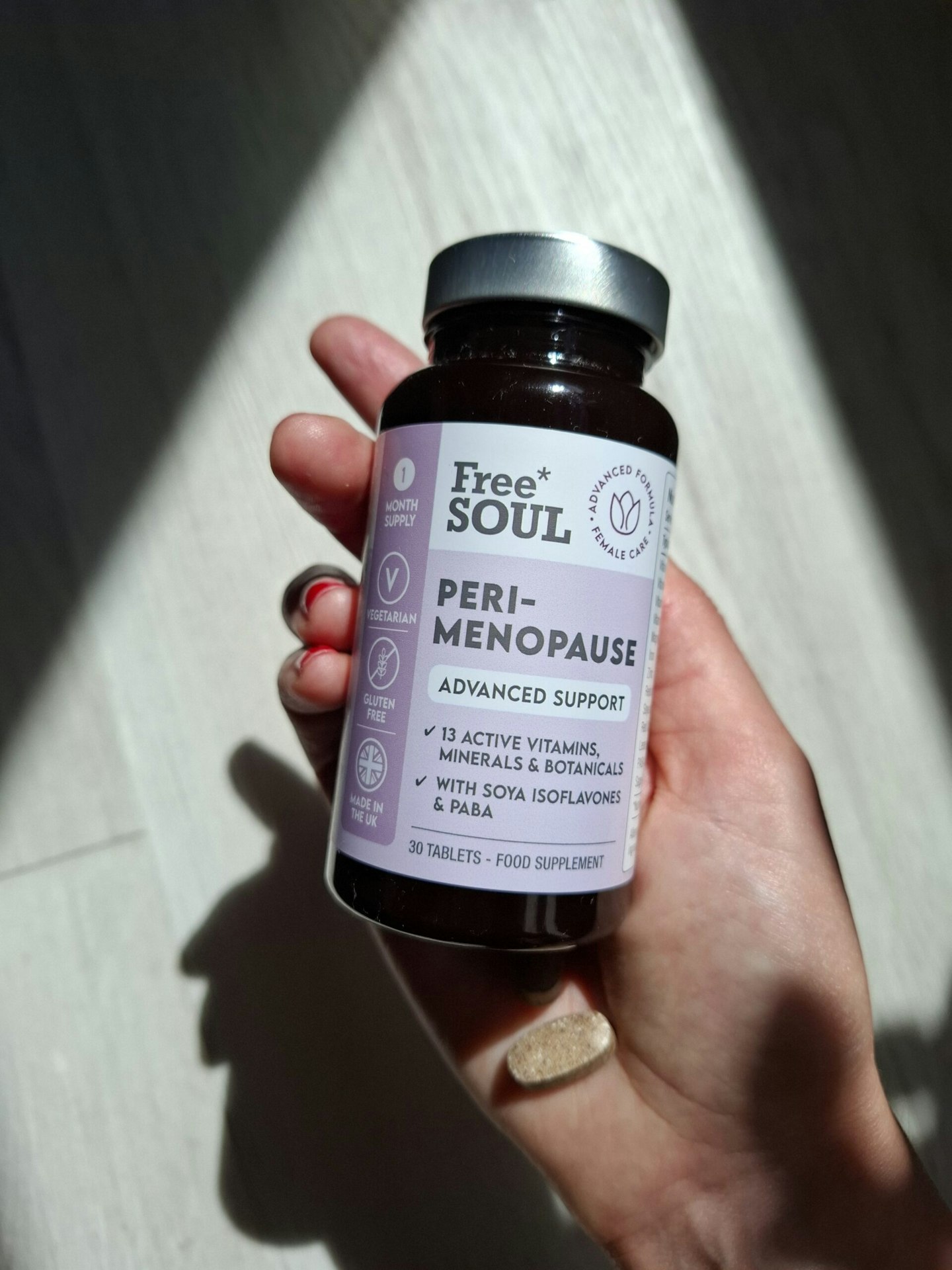 Tester holding a bottle of Free Soul Perimenopause supplements 