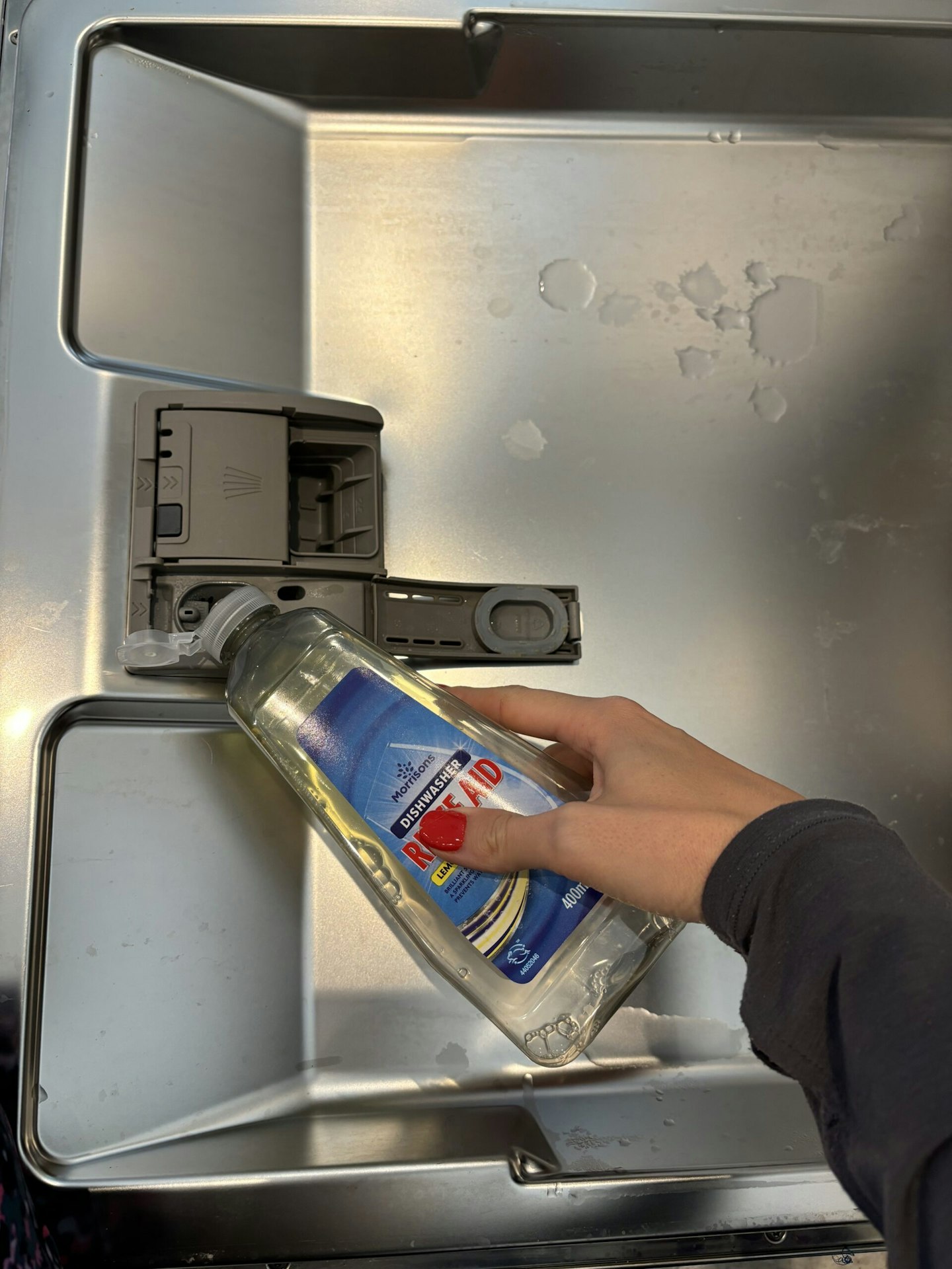 Yours.co.uk editor Claire Tapley pours Rinse aid into the slot in her dishwasher