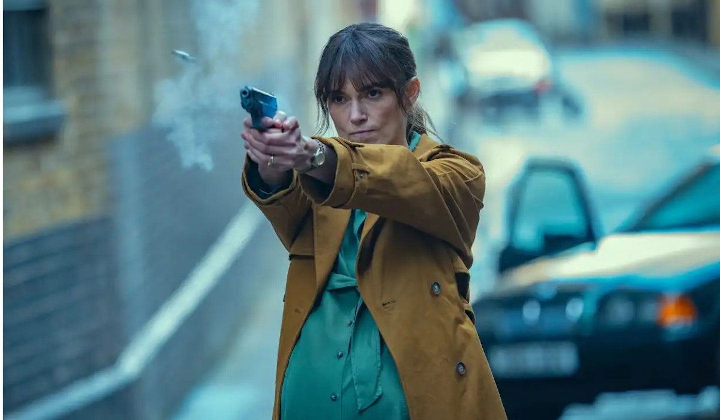 Black Doves Helen (Kiera Knightley) firing a gun in broad daylight on the street.