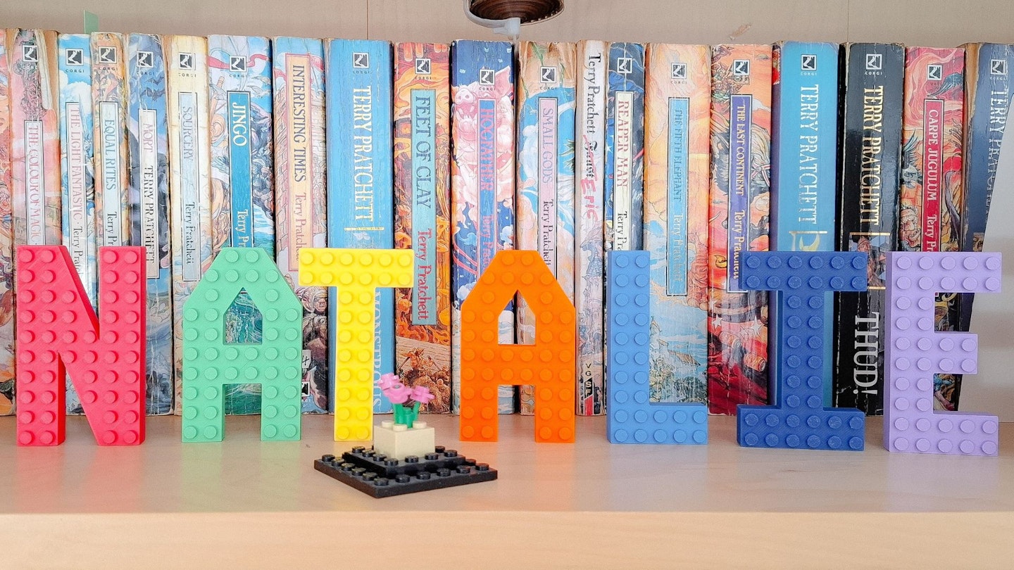 Made Happy brick letters that spell 'Natalie' on a book shelf