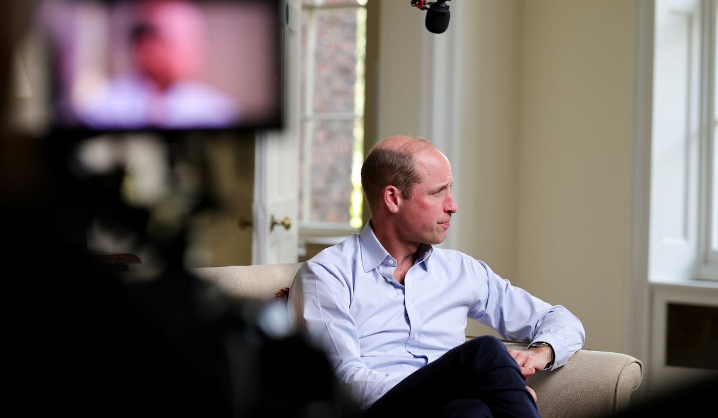 William filming for Prince William: We Can End Homelessness, sat down and looking away from the camera.