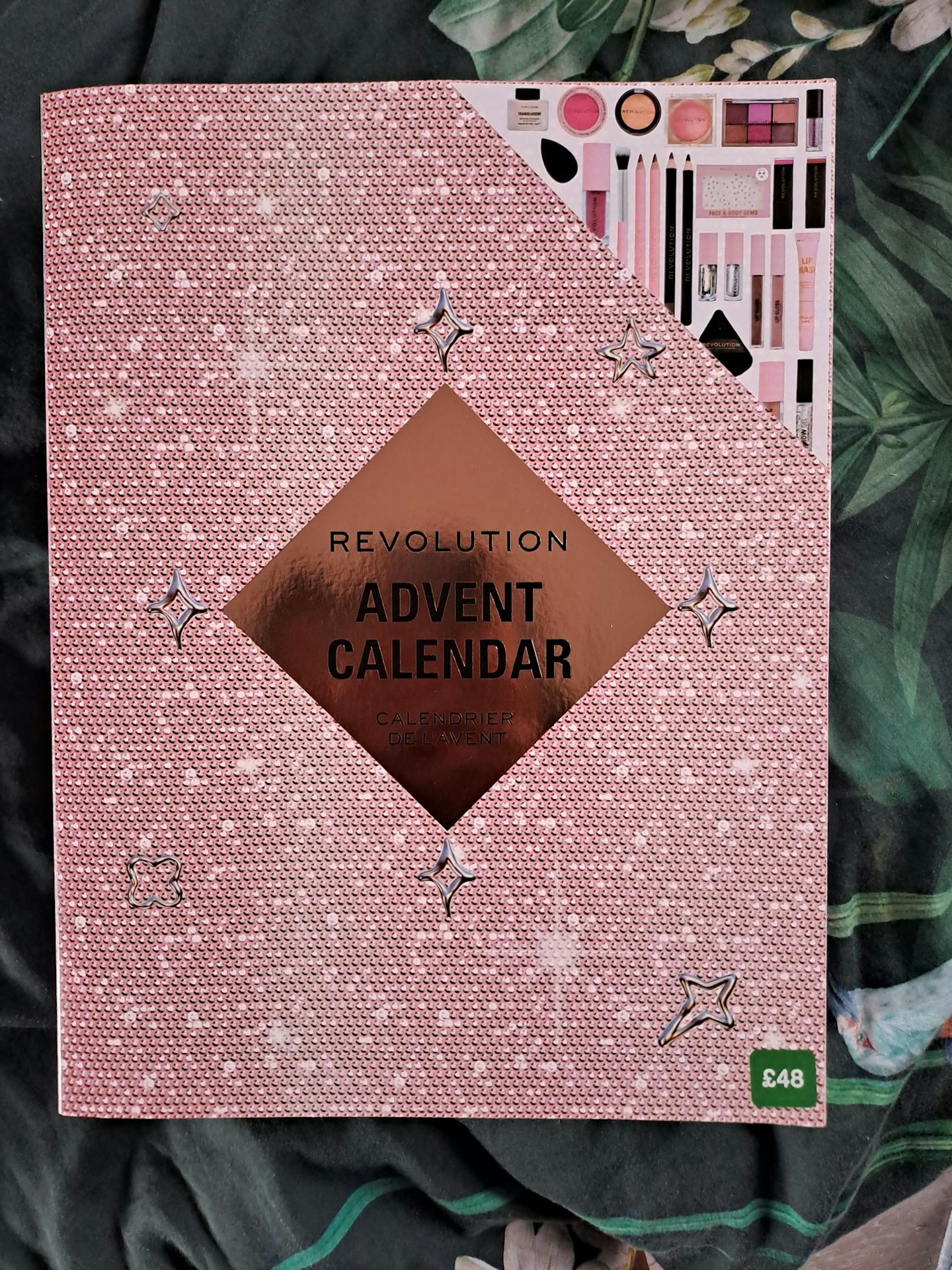 Image of Revolution Advent Calendar against a dark green floral background