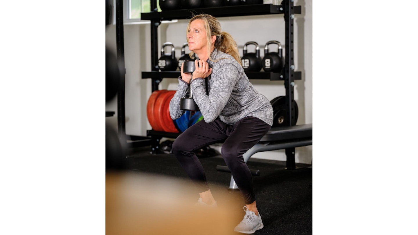 Sally Gunnell doing a goblet squat with a dumbbell