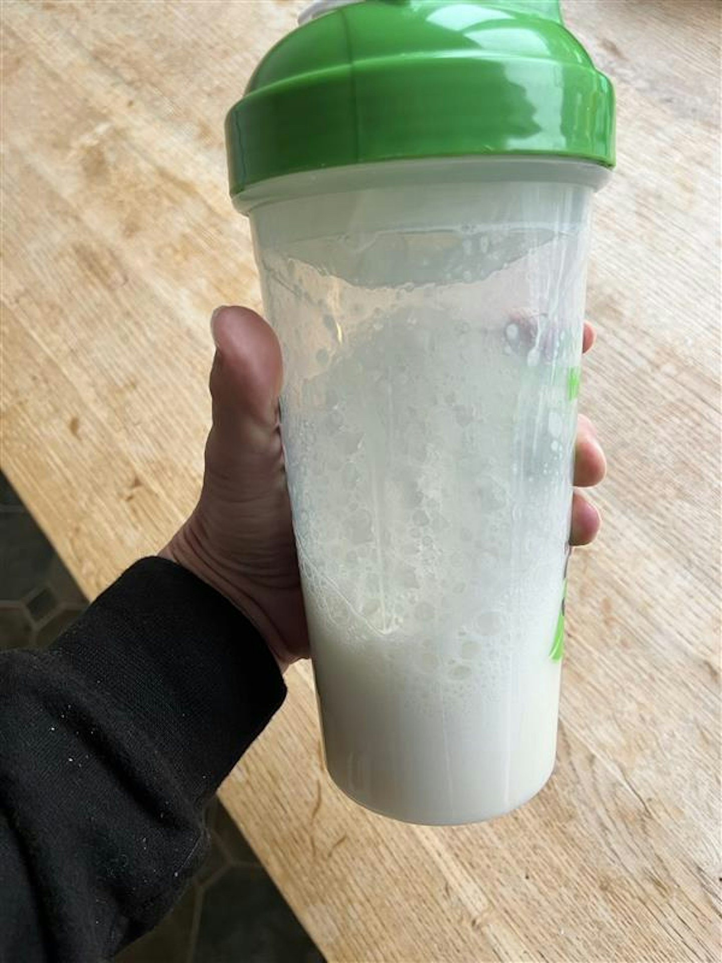 Warrior whey protein shake in a plastic shaker cup 