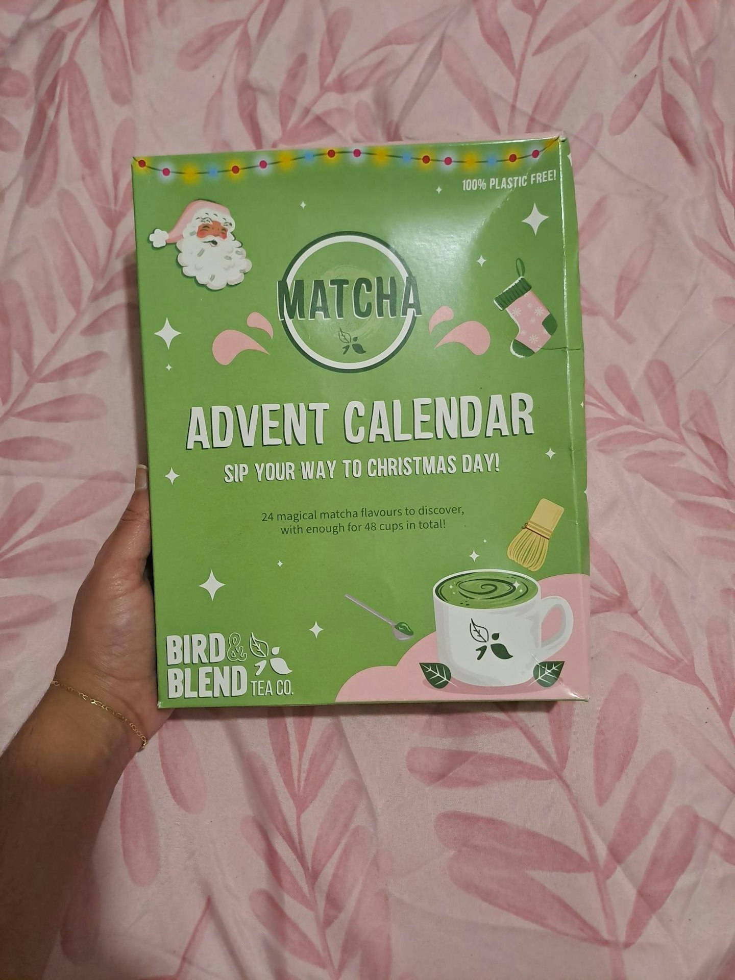 Reviewer holding the Bird & Blend Tea Co. Matcha Advent Calendar against a pink background 