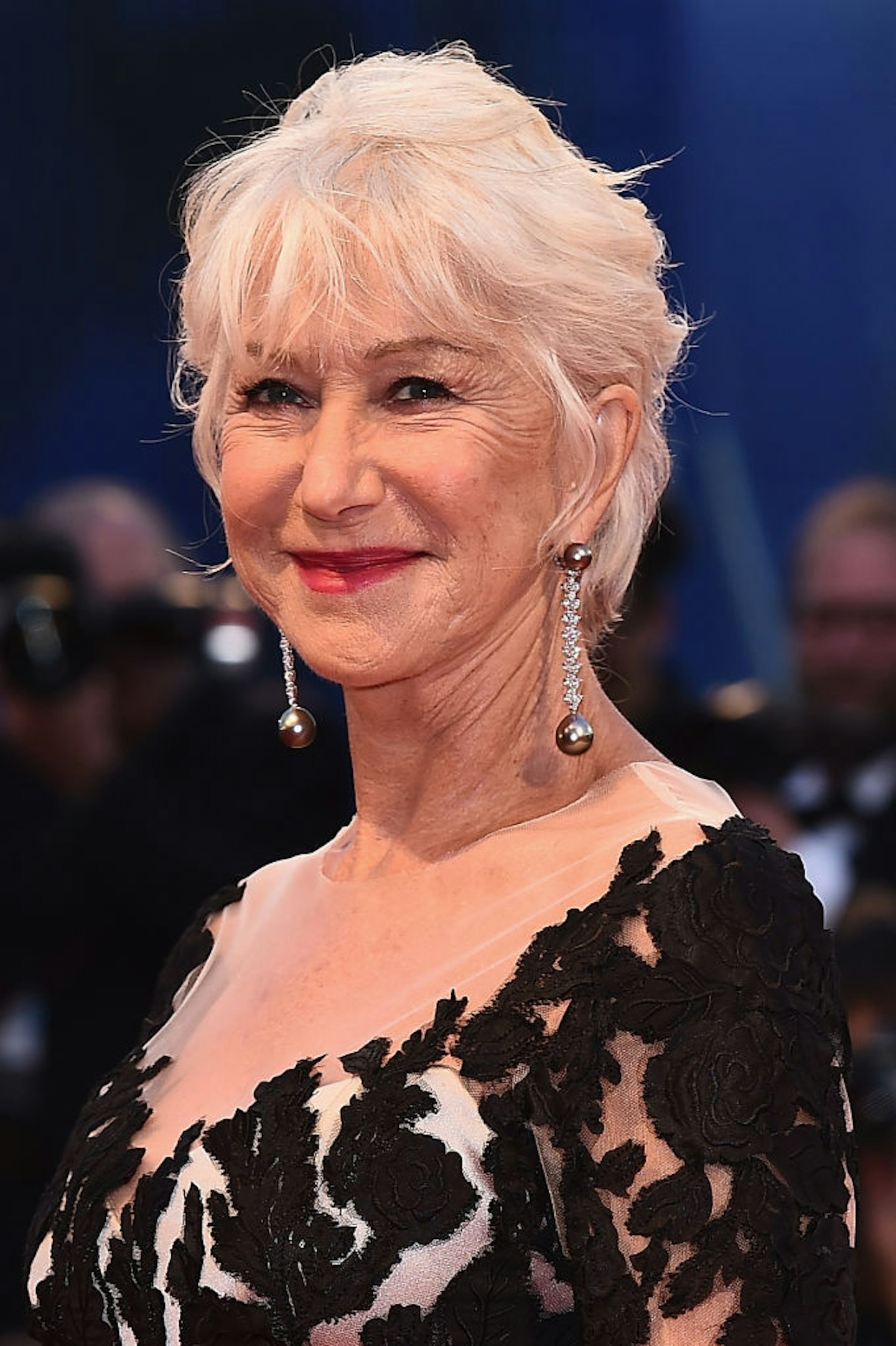 Helen Mirren in a black and white dress with a wispy bob cut