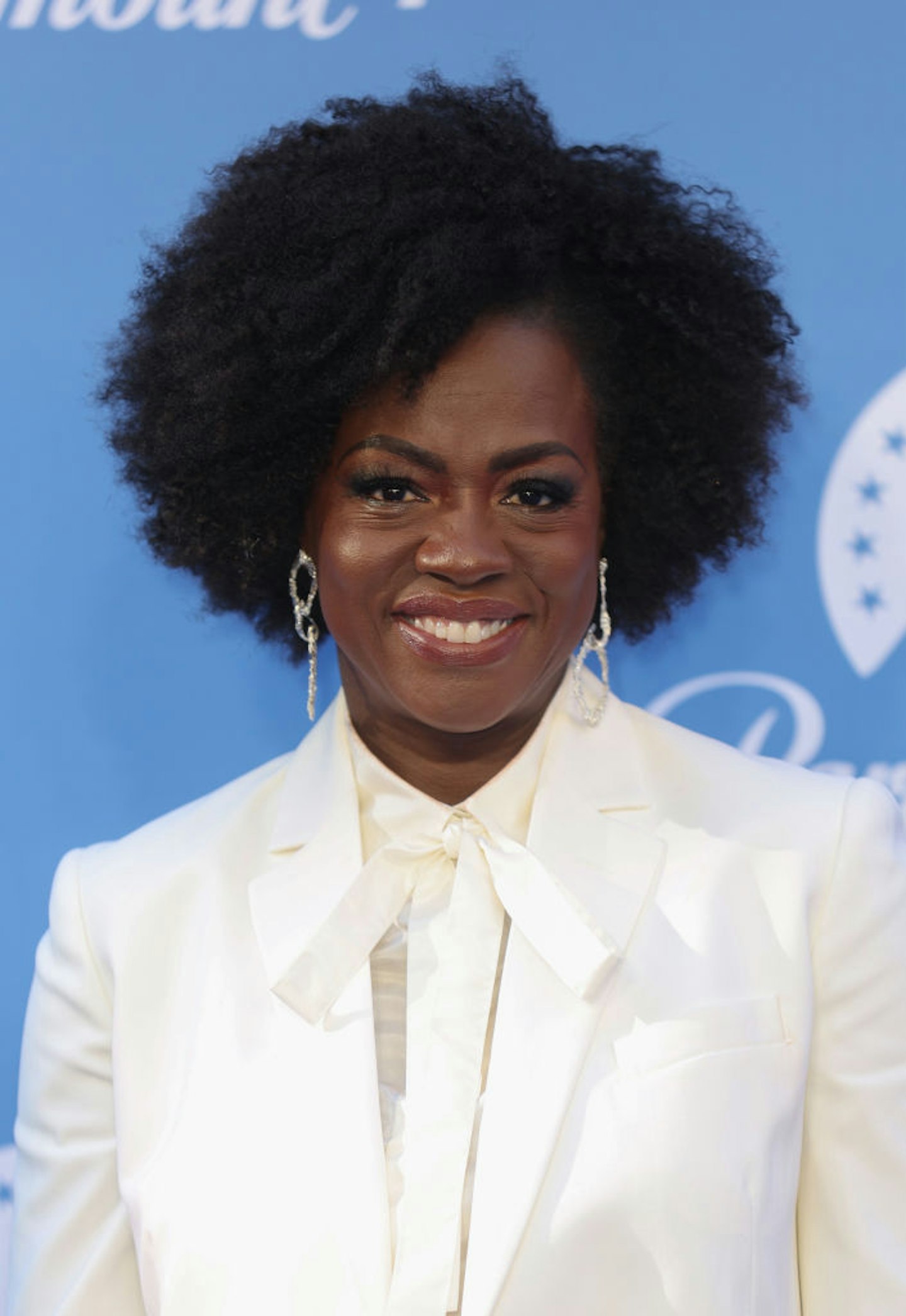 Viola Davis in a white suit with a choppy bob