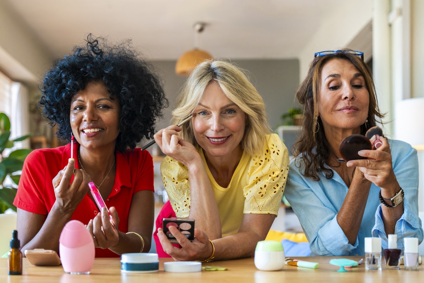 Group of multiracial older women applying makeup