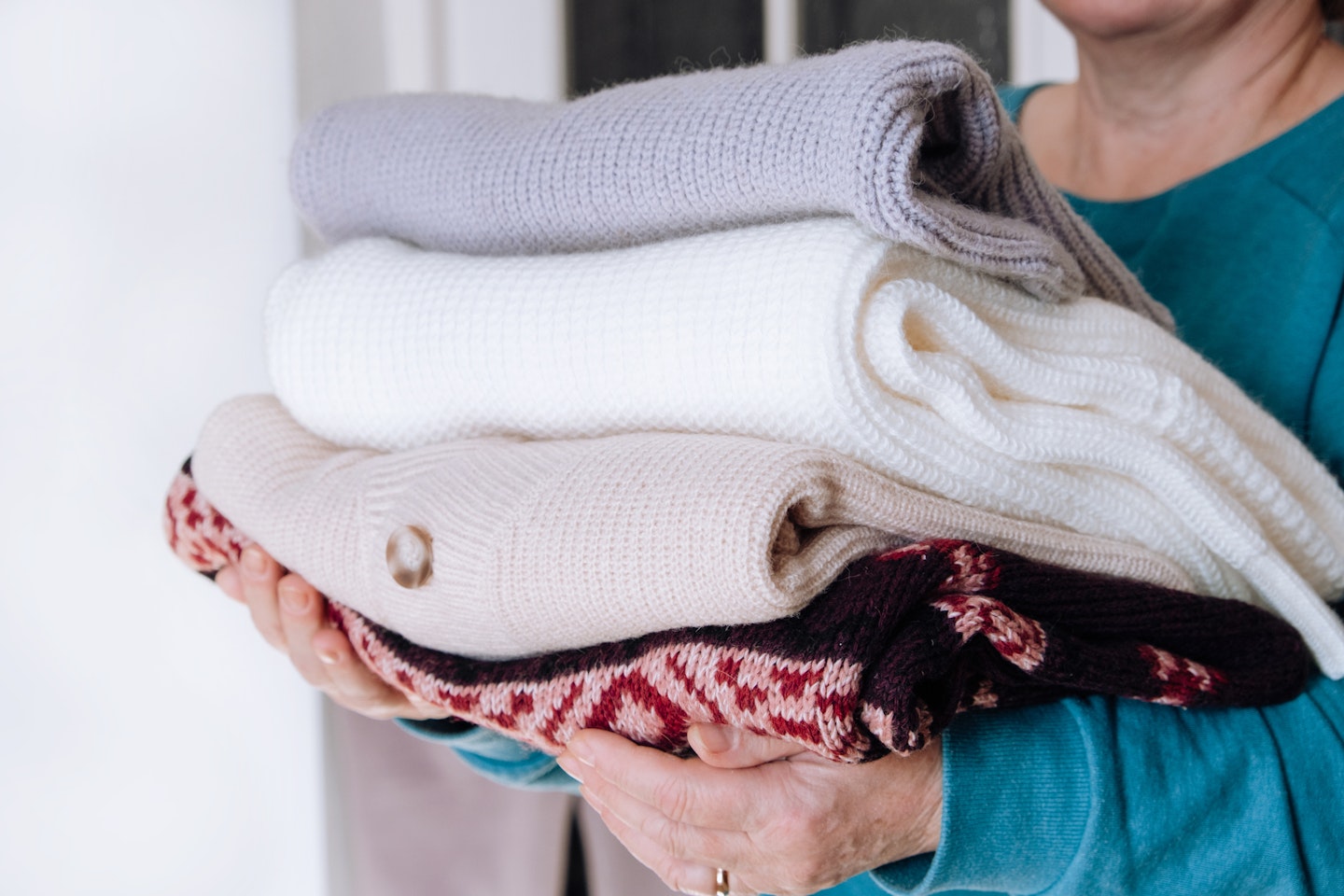 Woman carrying washed woollen clothes