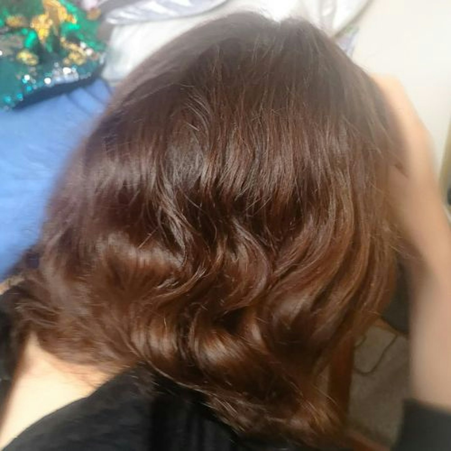 Back of tester's head, showing naturally curly brown hair