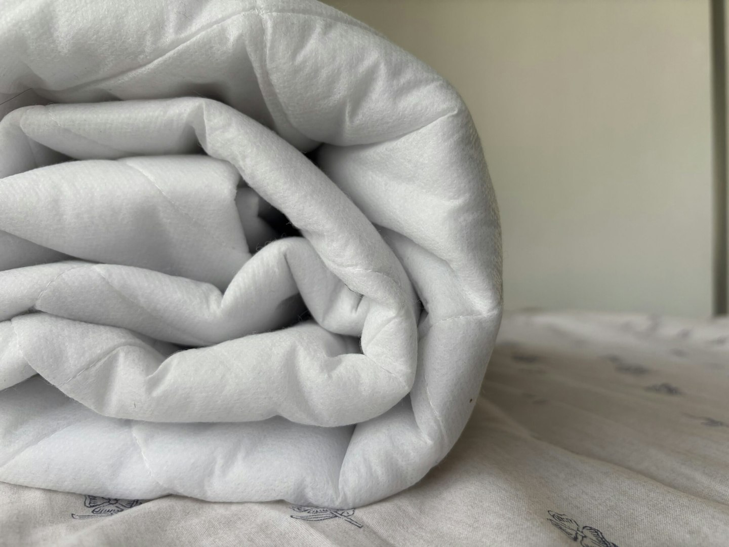 A duvet kept rolled on the bed