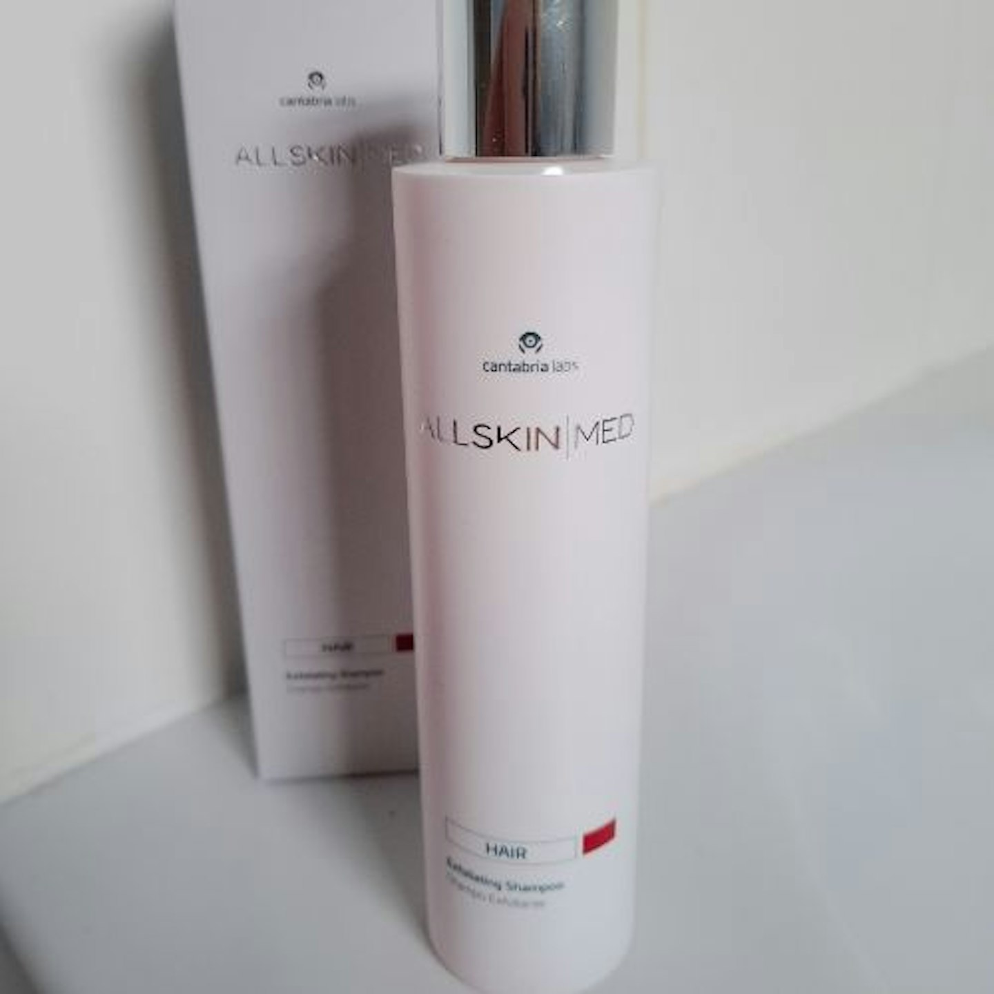 Front view of ALLSKIN|MED Exfoliating Shampoo bottle and packaging