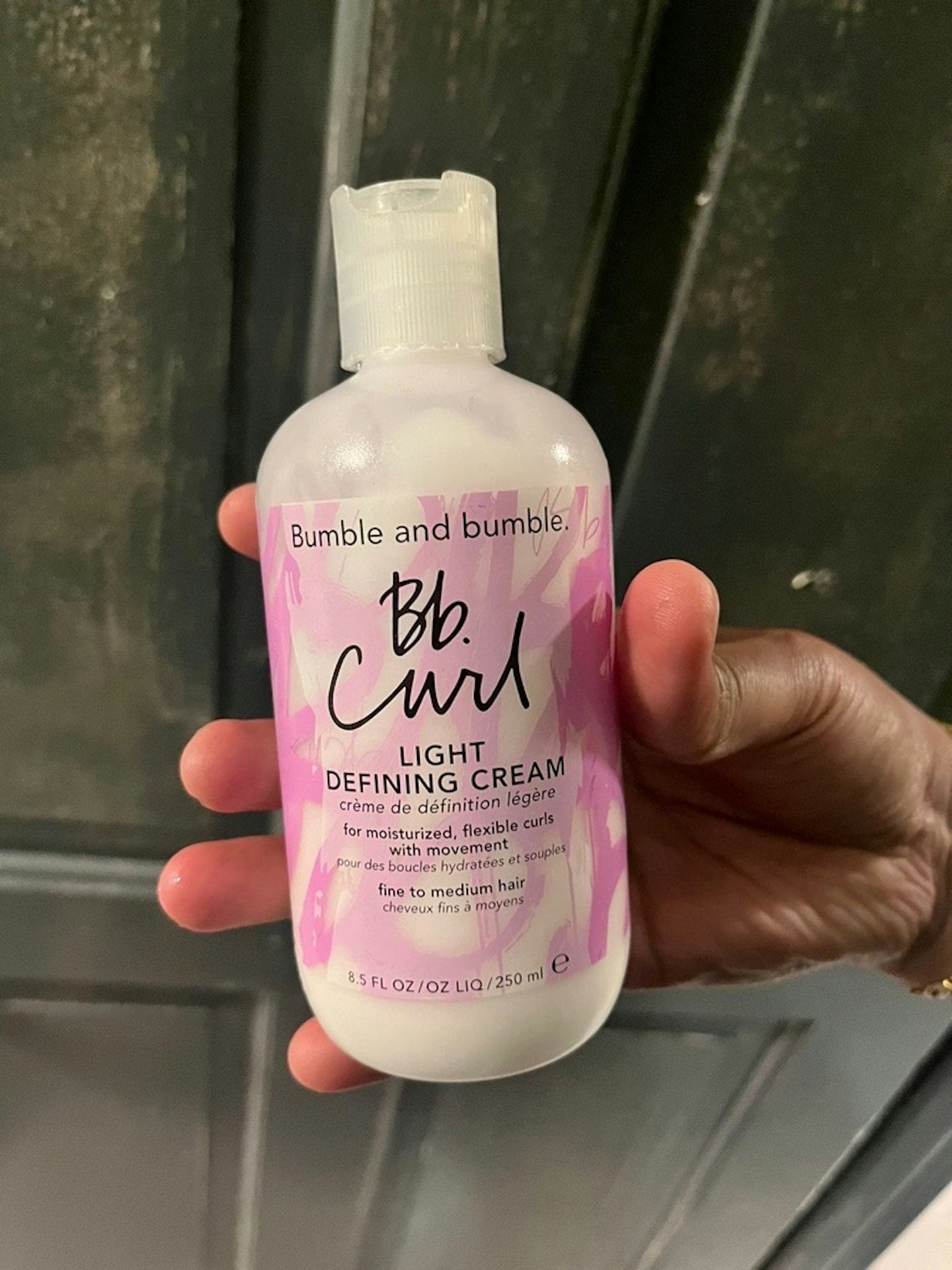 Image of tester holding the Bumble and bumble Curl Defining Cream