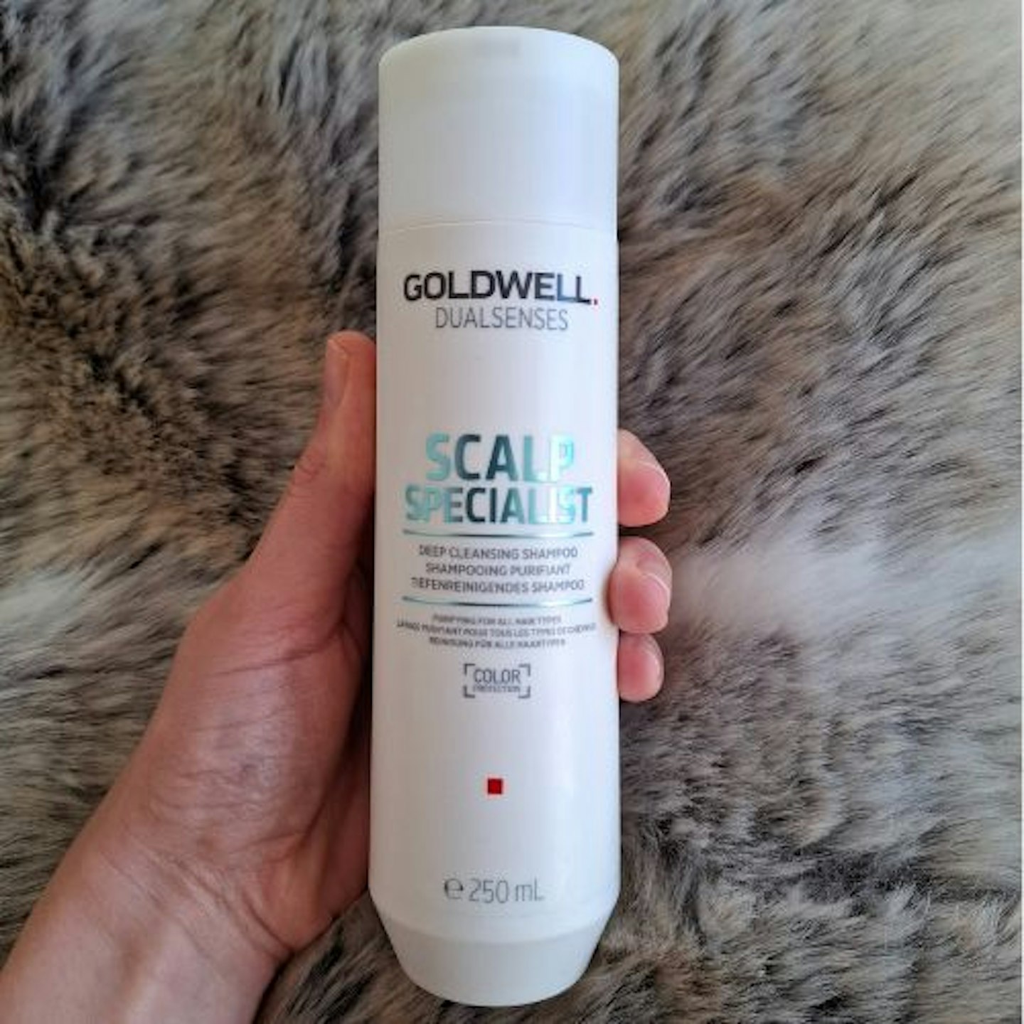 Front view of the bottle of Goldwell Dualsenses Scalp Specialist Densifying Shampoo in tester's hand